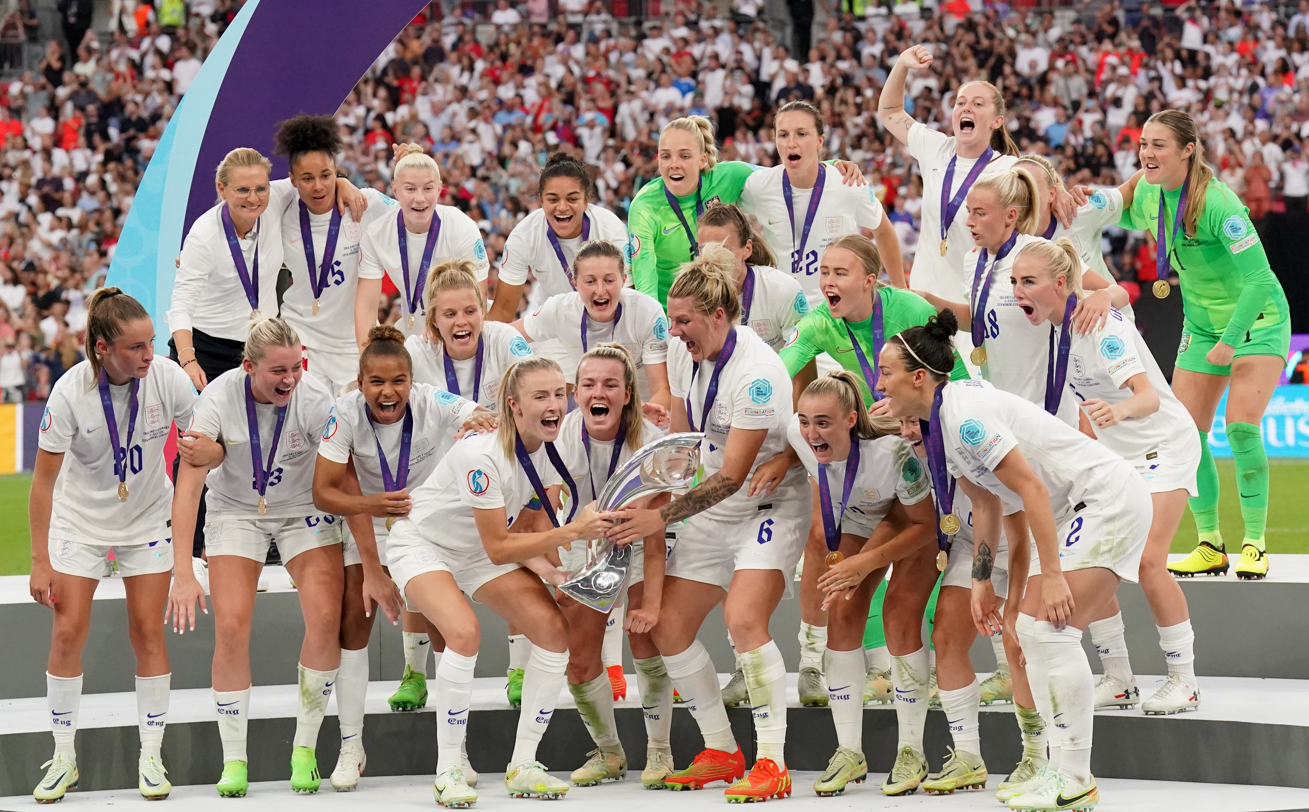 England’s Leah Williamson and Millie Bright lift the trophy as England celebrate winning the UEFA Women’s Euro 2022 final at Wembley (Jonathan Brady/PA)