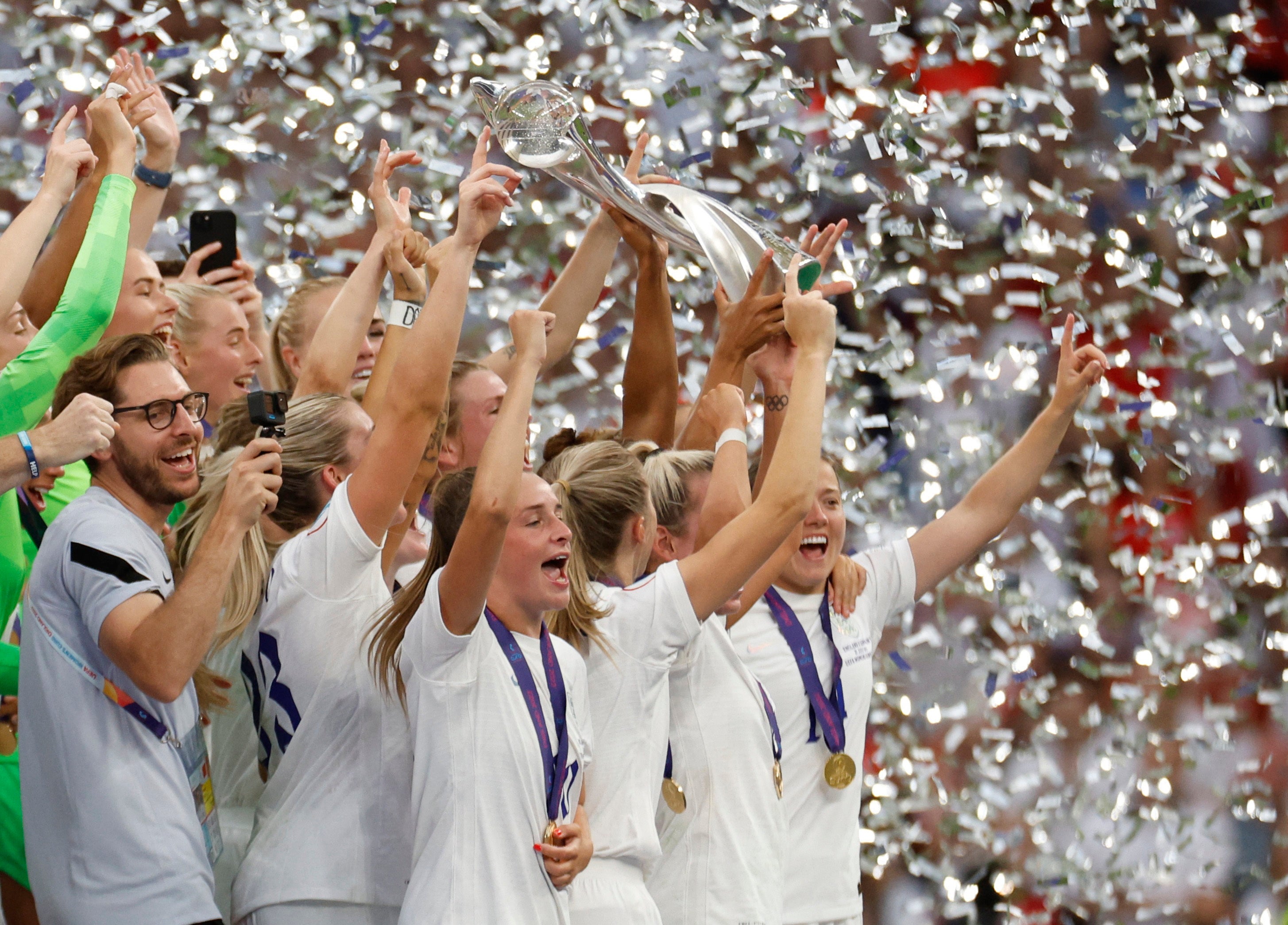 Leah Williamson and Millie Bright lift the trophy as they celebrate with teammates after winning the Women’s Euro 2022