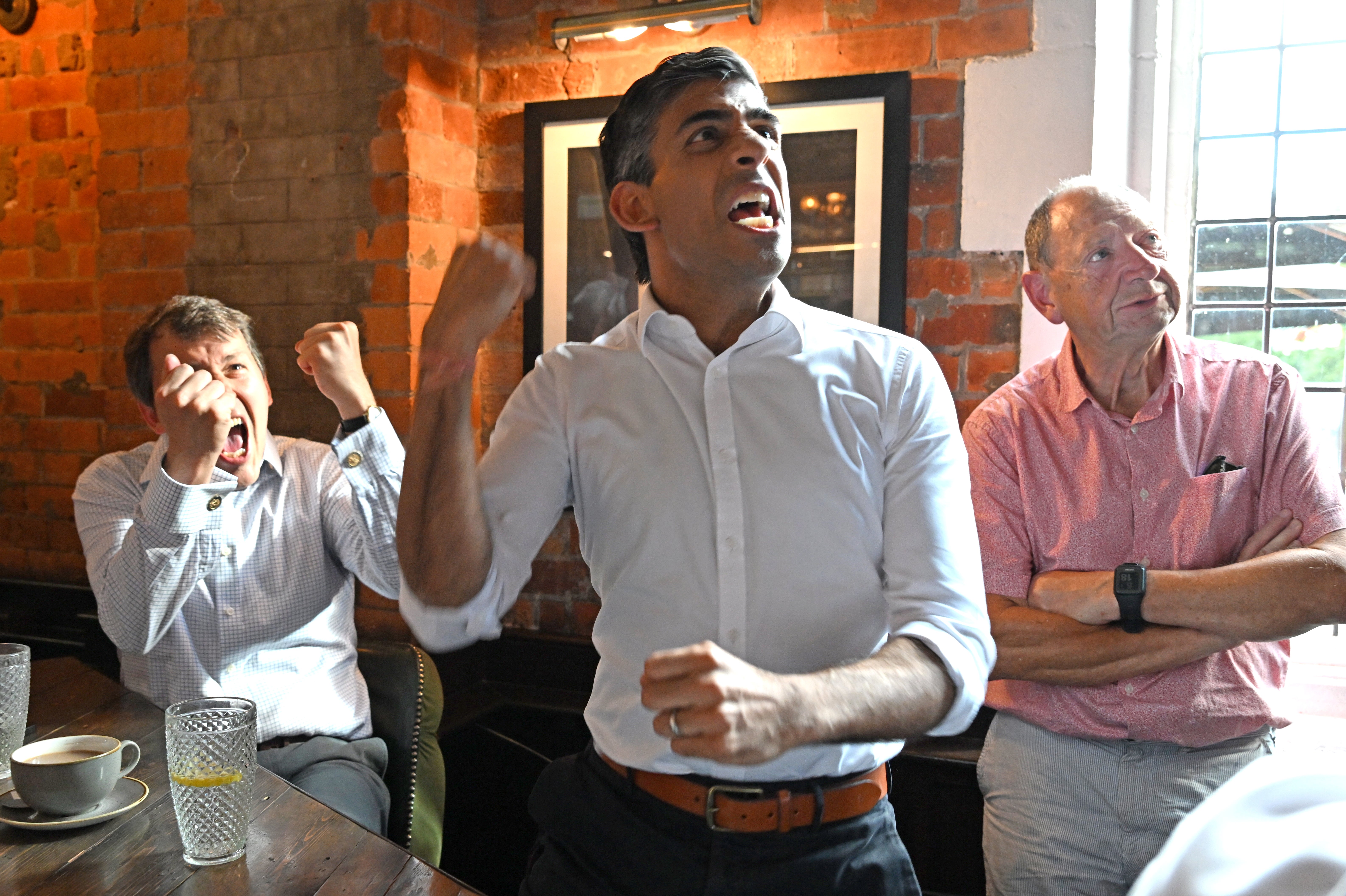 Rishi Sunak in Salisbury celebrates England’s first goal (Finnbarr Webster/PA)