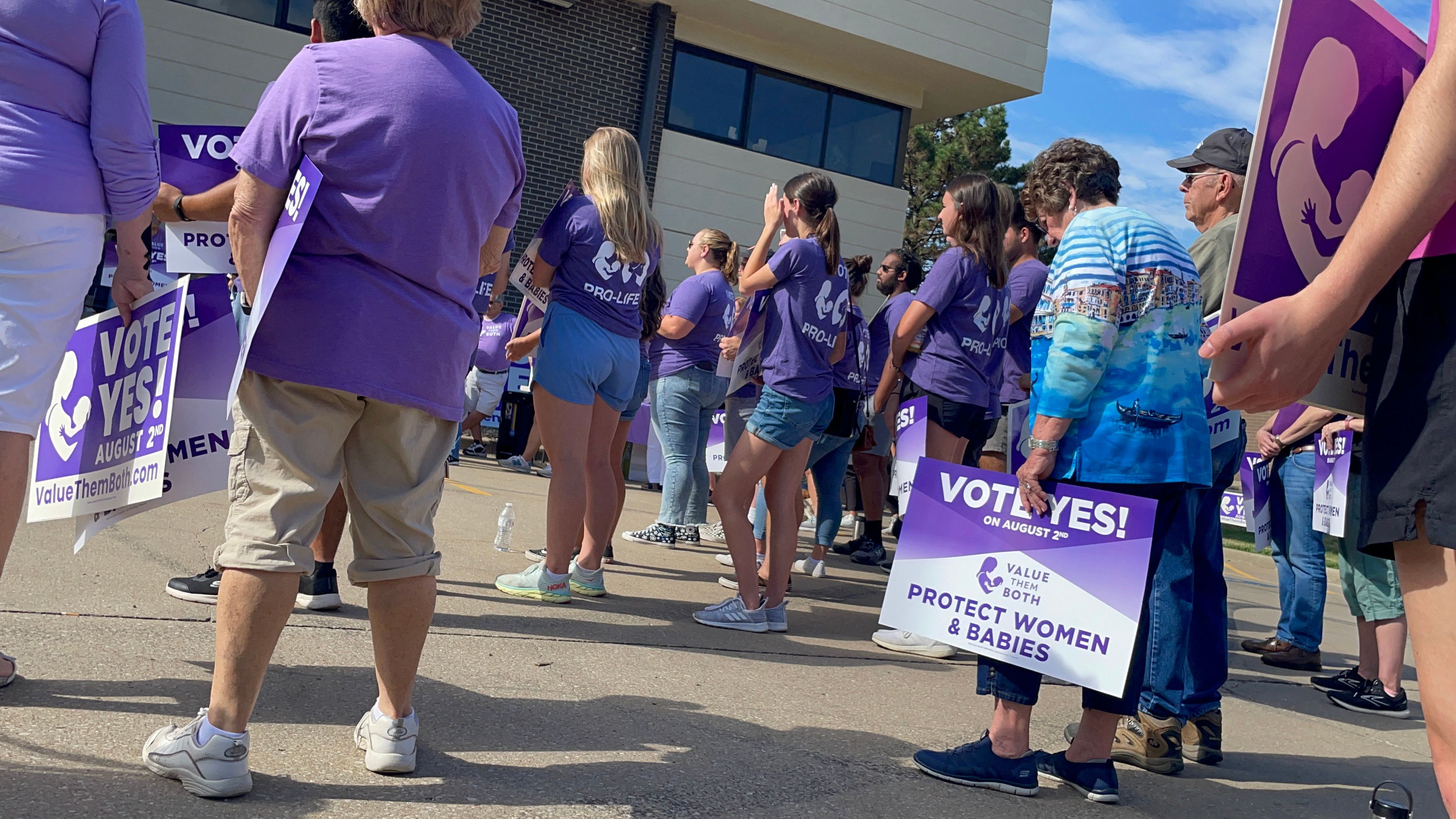 Anti-abortion supporters of a state constitutional amendment to remove language enshrining abortion rights in Kansas hold a rally on 30 July.