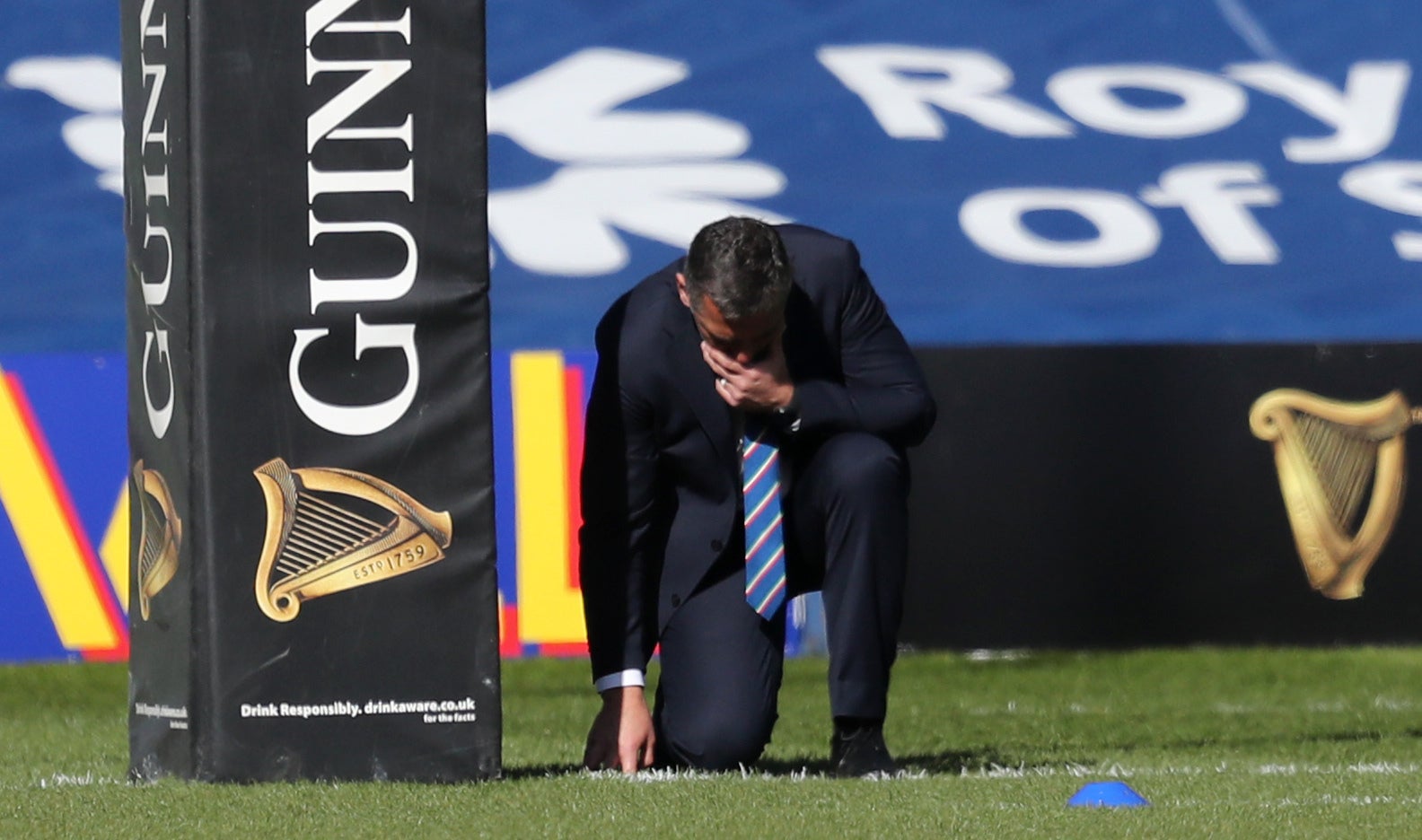 Franco Smith touches the pitch as he says a prayer before a Six Nations match at BT Murrayfield (Jane Barlow/PA)