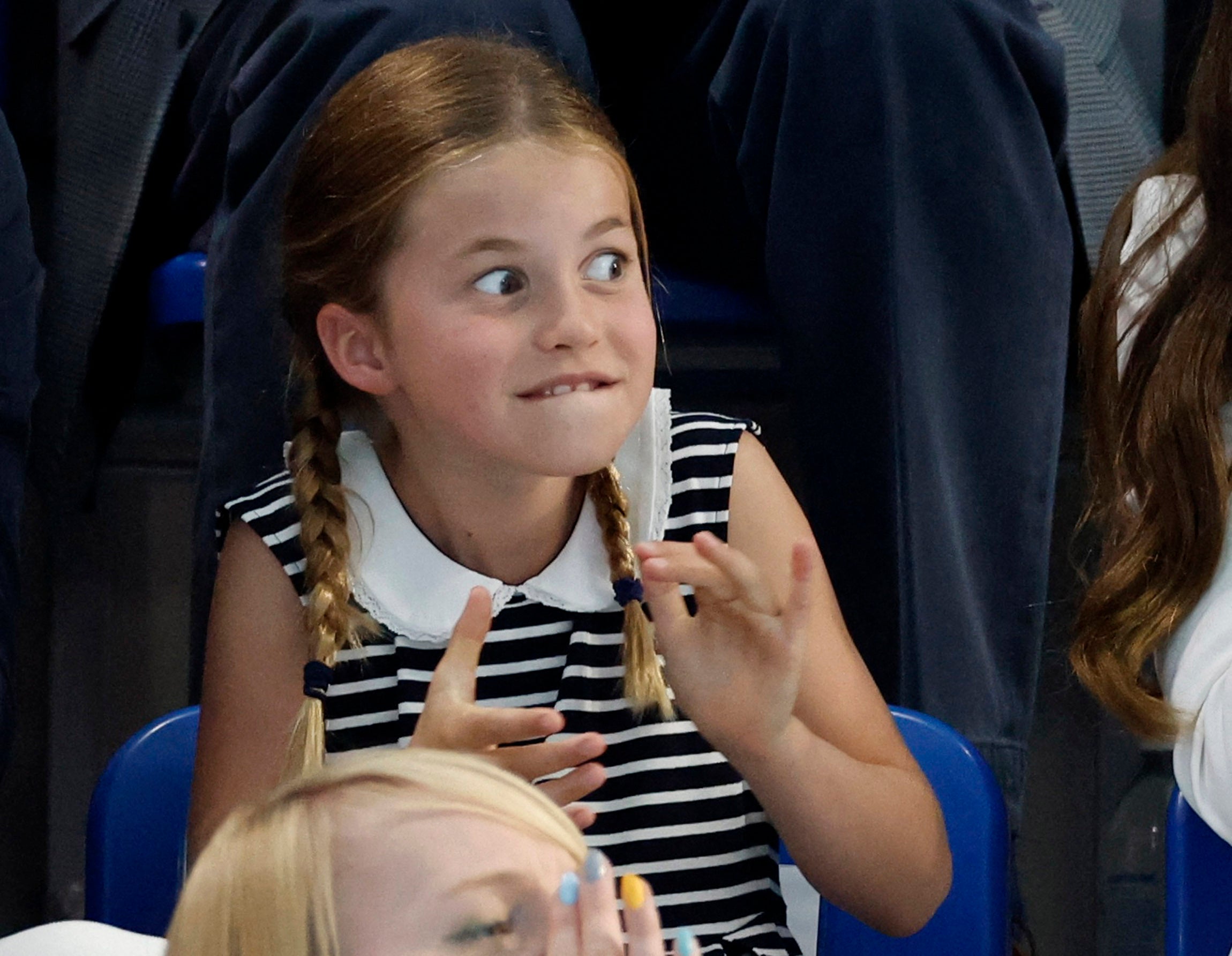 Princess Charlotte pulls a face in the stands