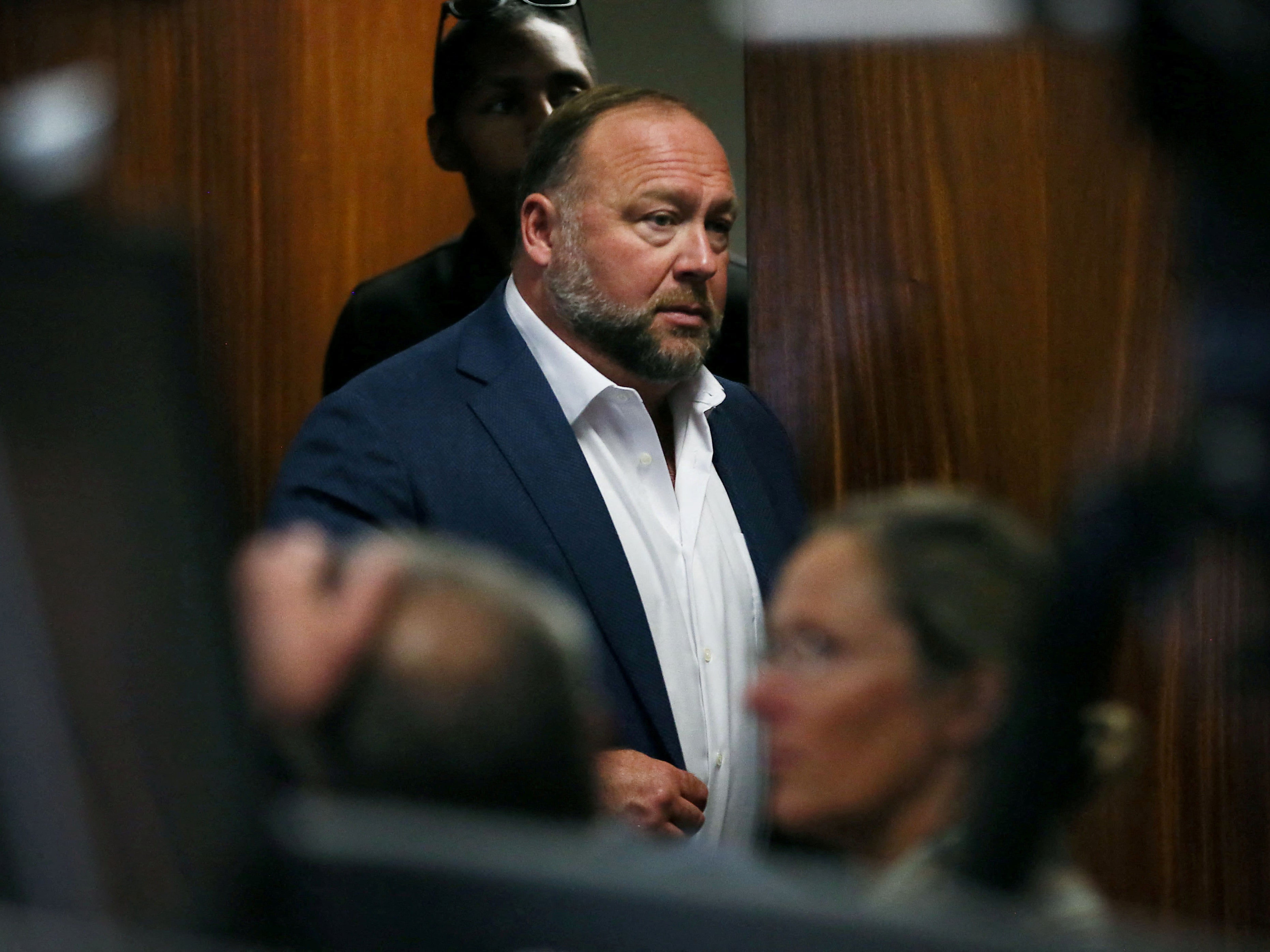 Alex Jones walks into the courtroom in front of Scarlett Lewis and Neil Heslin last week