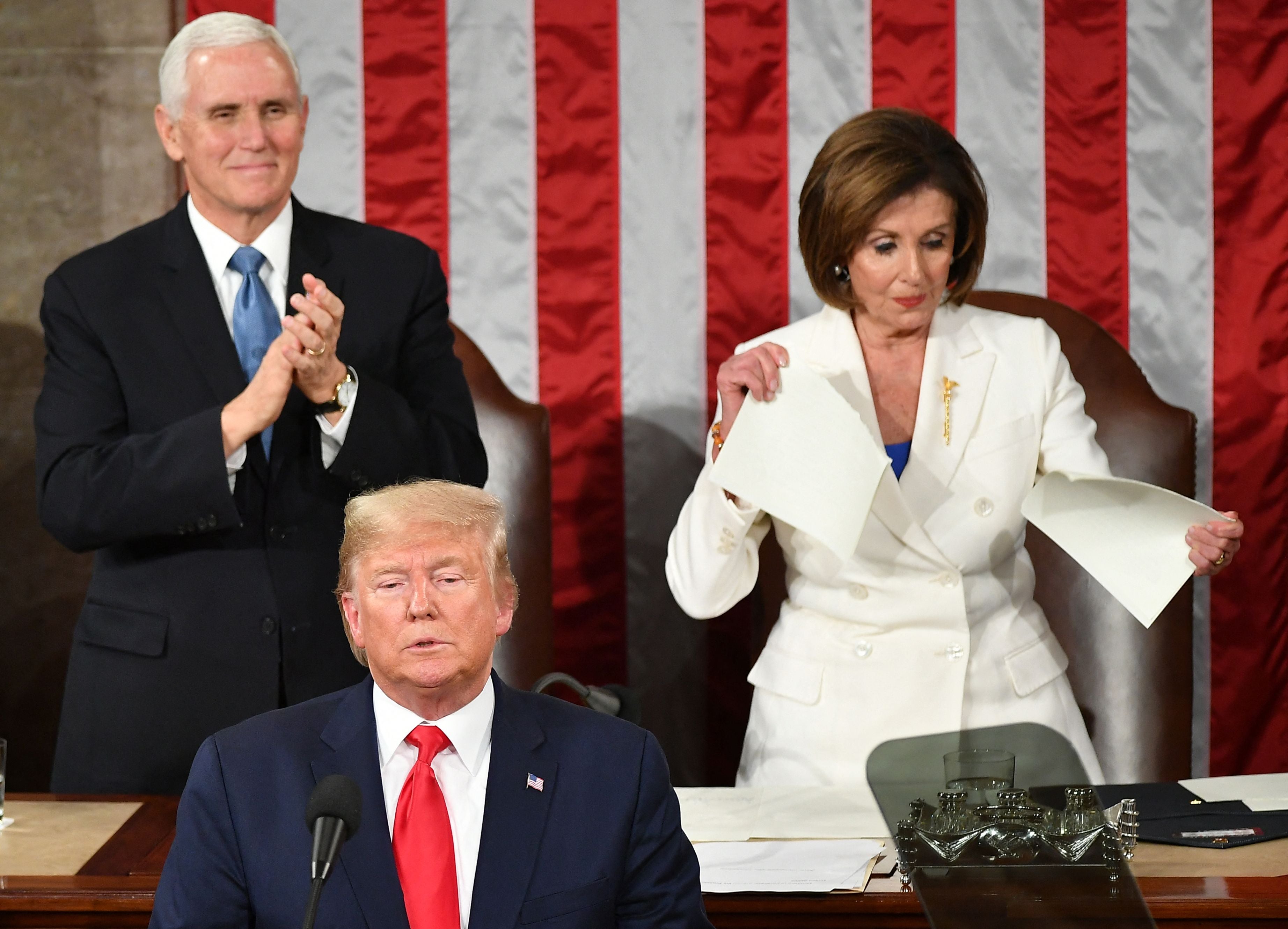 US Vice President Mike Pence claps as Speaker of the US House of Representatives Nancy Pelosi appears to rip a copy of US President Donald Trumps speech after he delivers the State of the Union address at the US Capitol in Washington, DC, on February 4, 2020