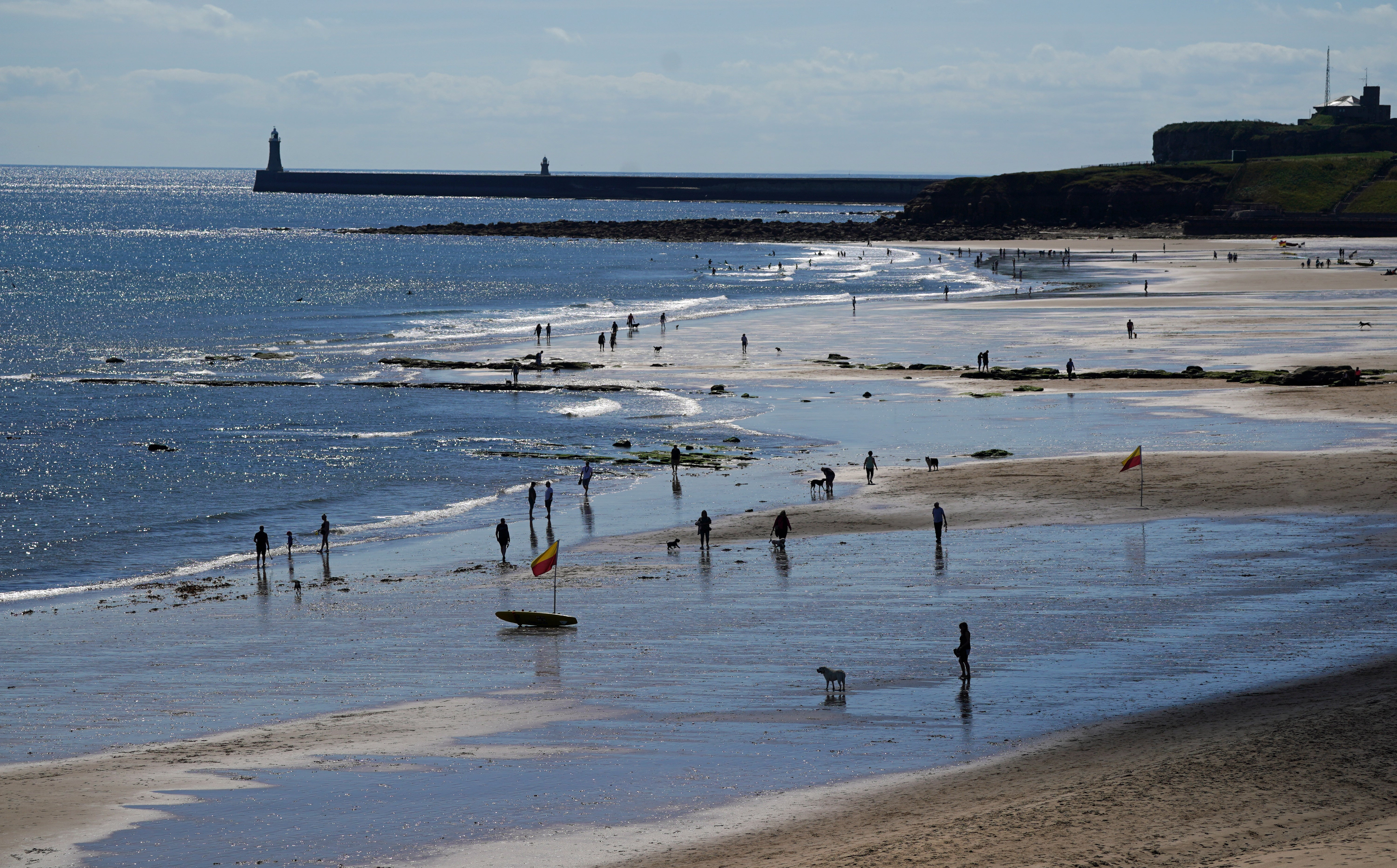 People enjoying the good weather at Tynemouth beach (Owen Humphreys/PA)