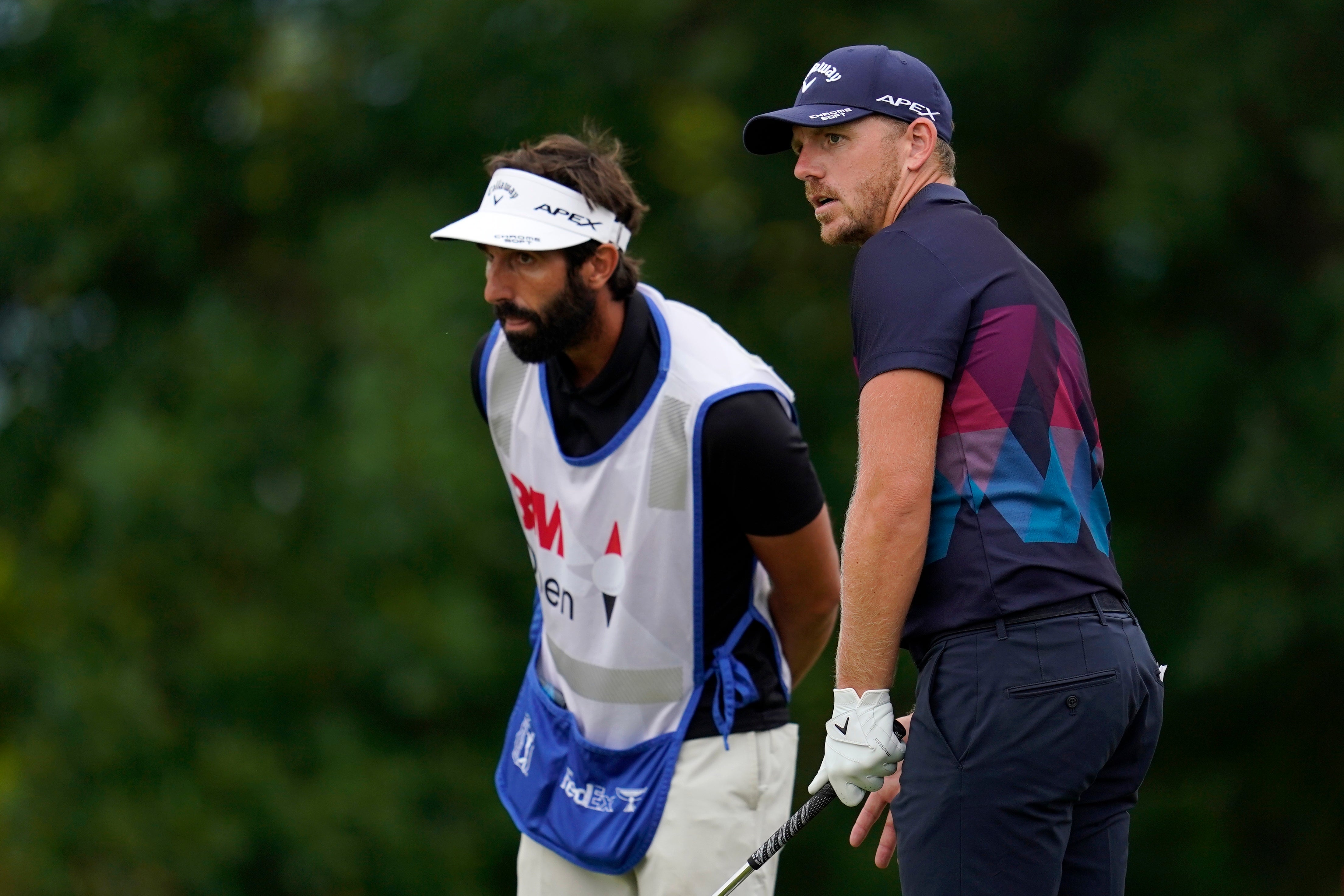 Matt Wallace talks with his caddie before his tee shot on the 10th hole during round three of the 3M Open (Abbie Parr/PA)