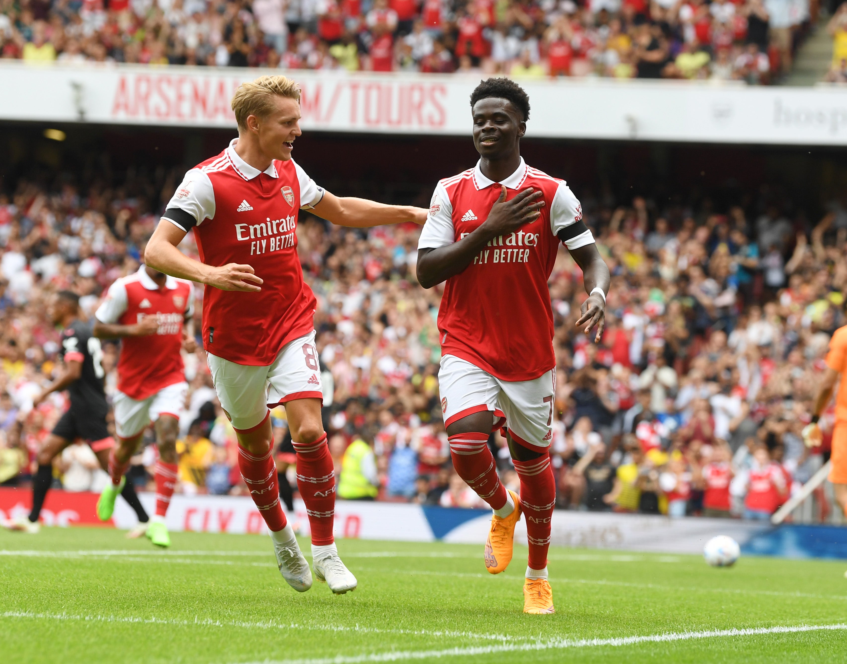 Bukayo Saka celebrates with Martin Odegaard after scoring in the Emirates Cup match against Sevilla