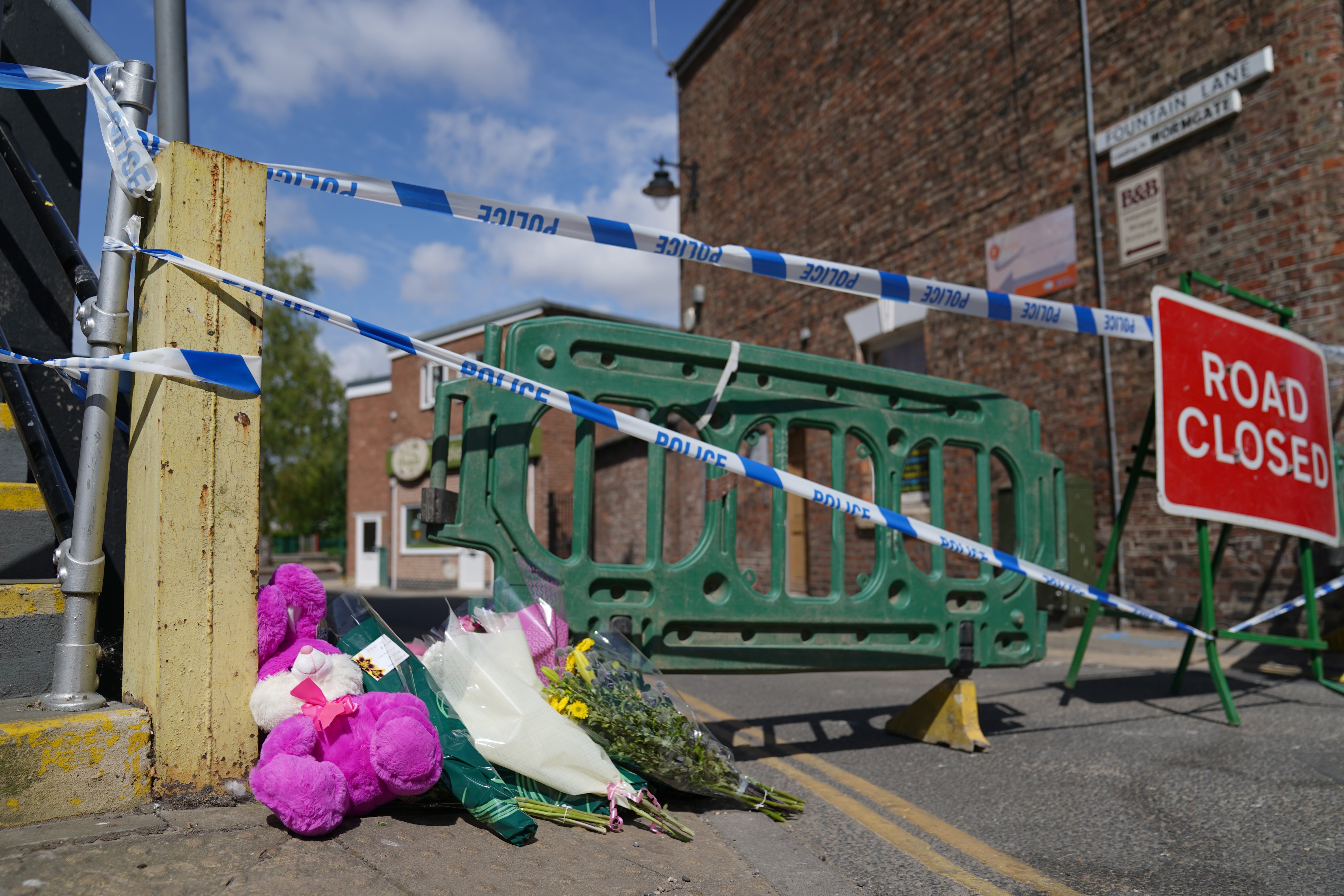 Floral tributes left near to the scene in Boston (Joe Giddens/PA)