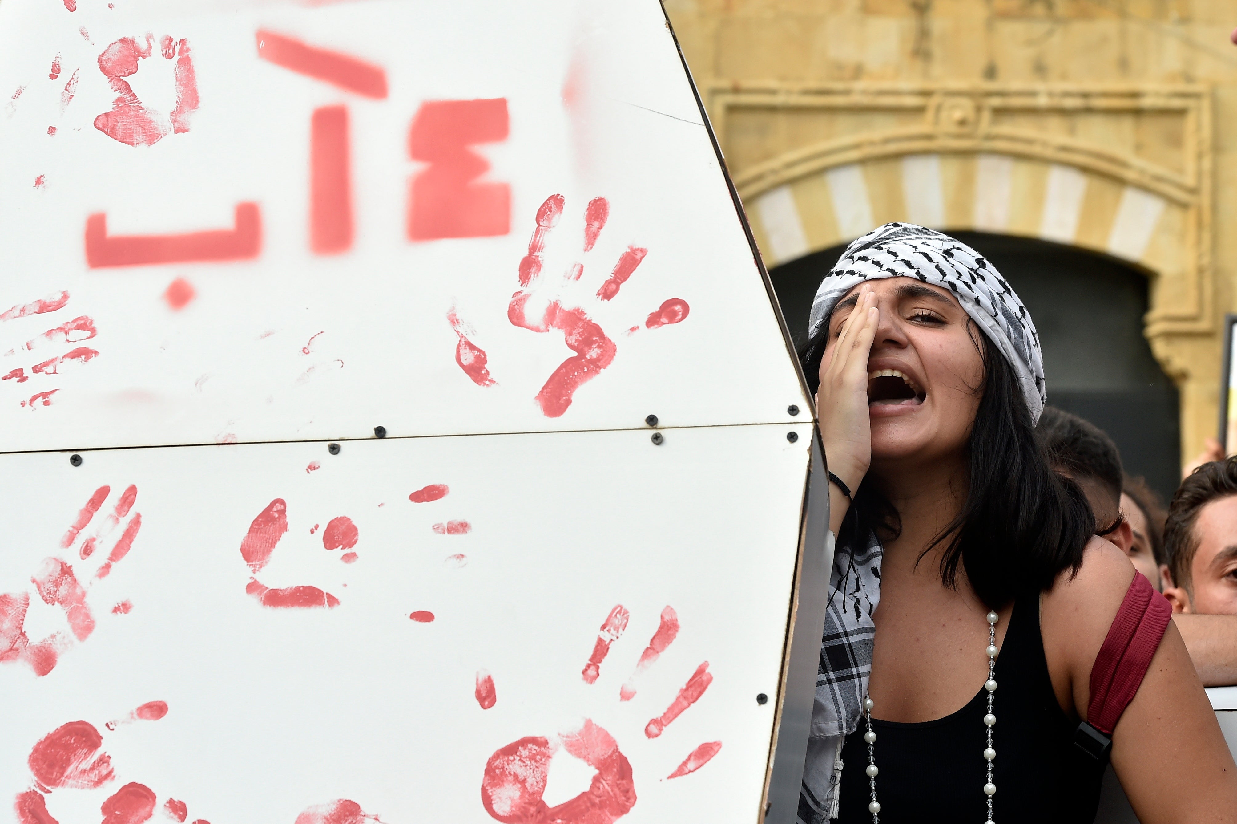 A Lebanese activist shouts slogans during the protest