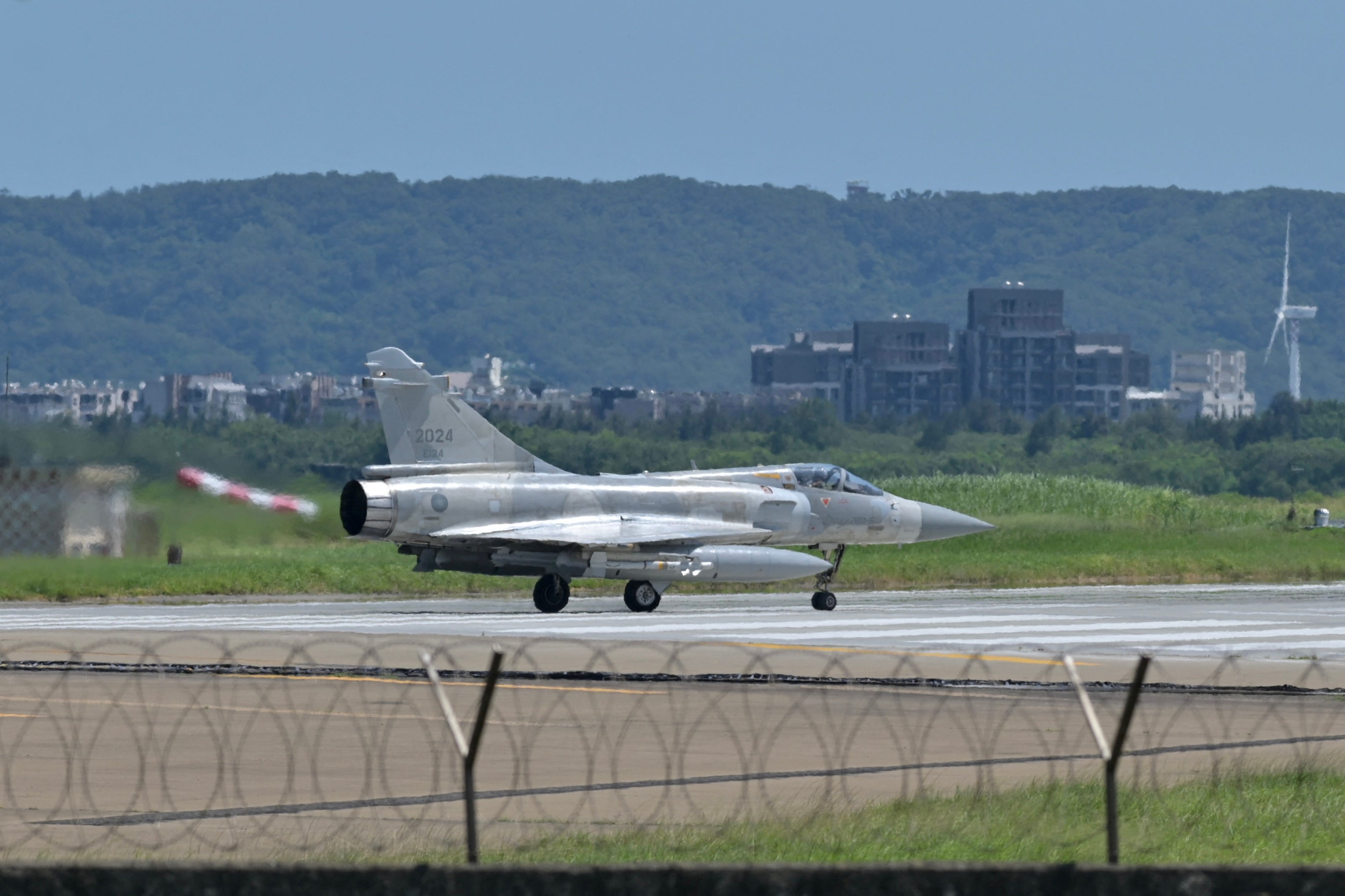 A French-made Mirage 2000 fighter jet taxis on a runway in front of a hangar at the Hsinchu Air Base in Hsinchu on 5 August 2022