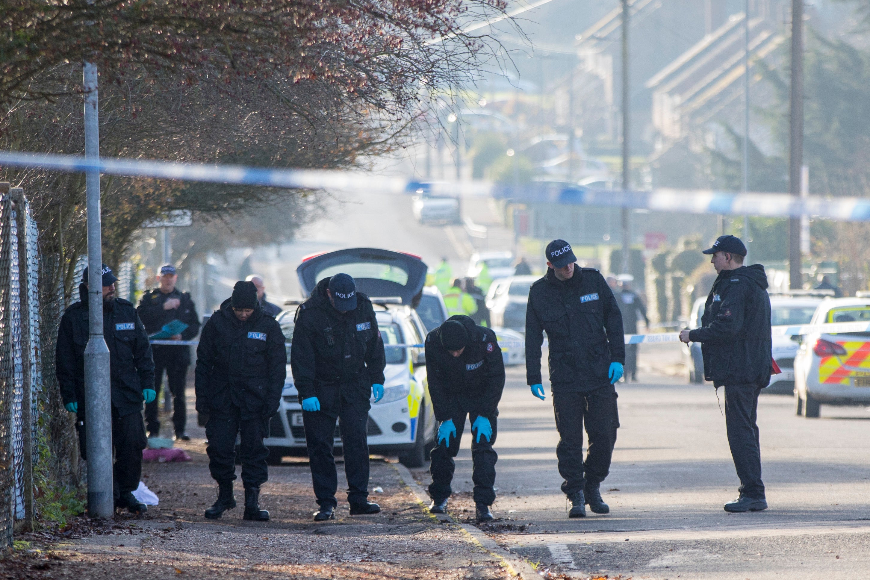 Police search teams make their way along Willingale Road in Loughton, Essex, near to Debden Park High School, as a murder investigation has been launched after a 12-year-old boy who was mowed down as he left school with his friends in what police believe was a deliberate hit-and-run crash.