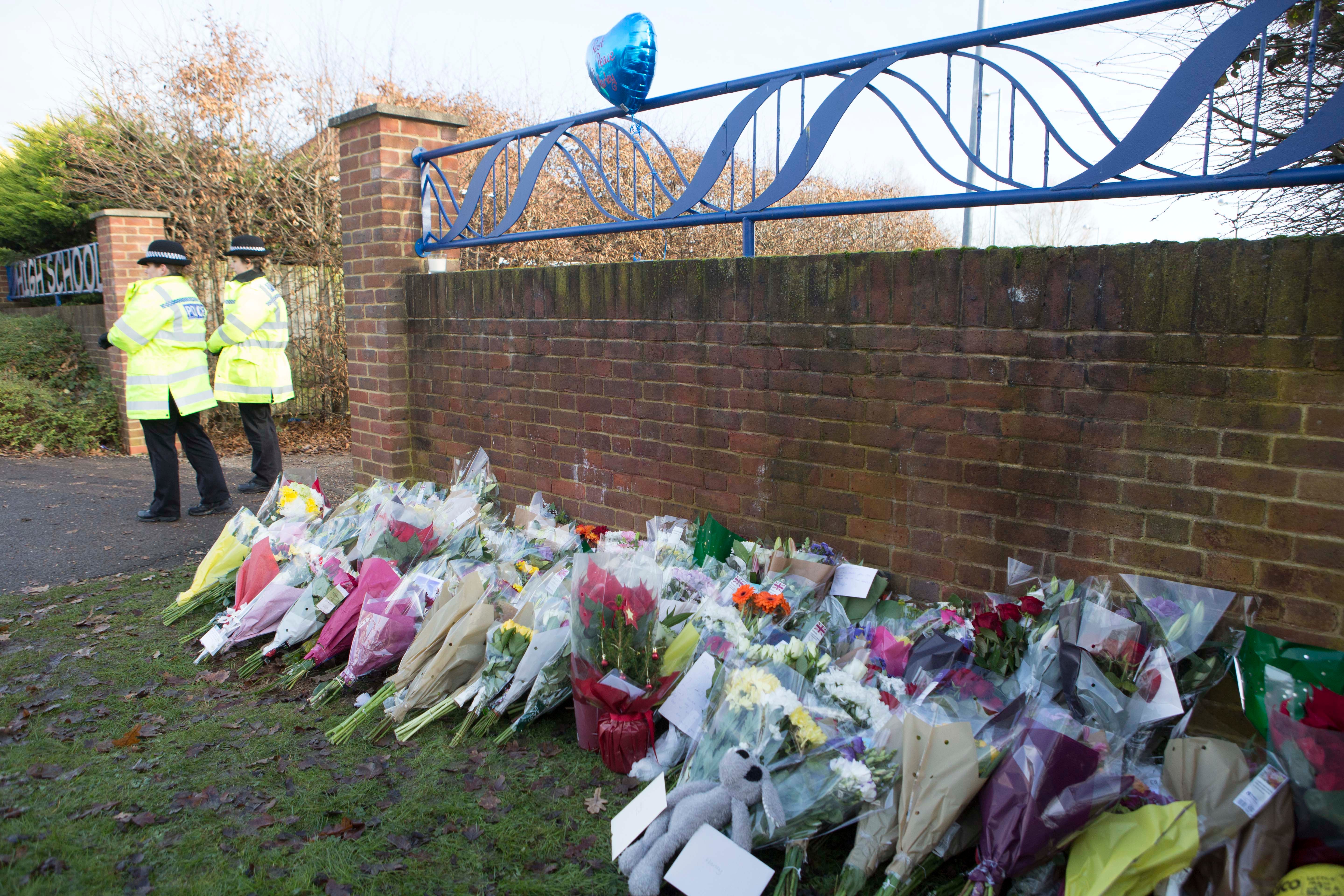 Floral bouquets left near the entrance to Debden Park High School, in Willingale Road, Loughton, Essex, as a murder investigation has been launched after a 12-year-old boy who was mowed down as he left the school with his friends in what police believe was a deliberate hit-and-run crash.