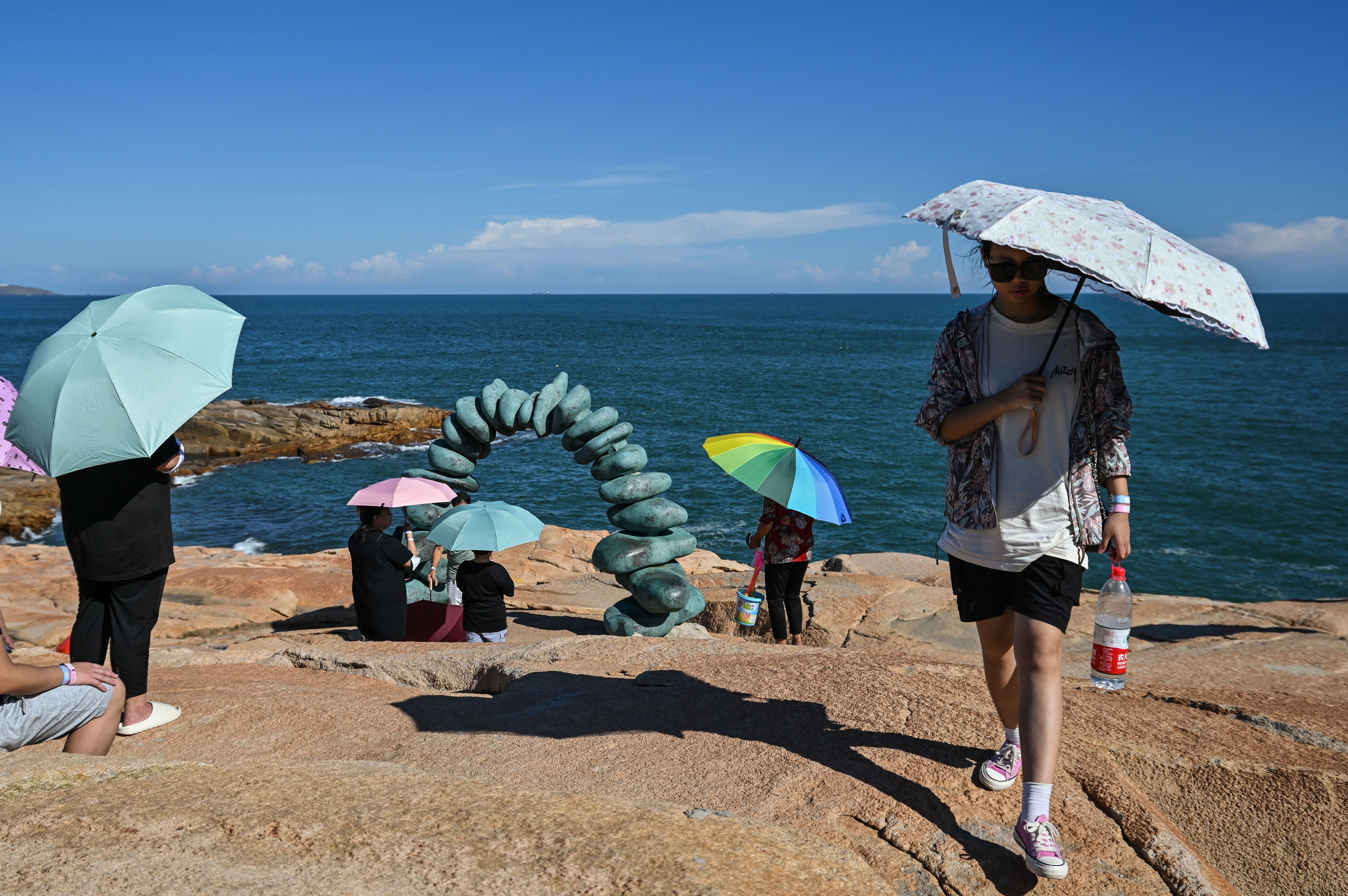 Tourists visit a scenic area on Pingtan island, one of mainland China’s closest point from Taiwan, in Fujian province on 5 August 2022