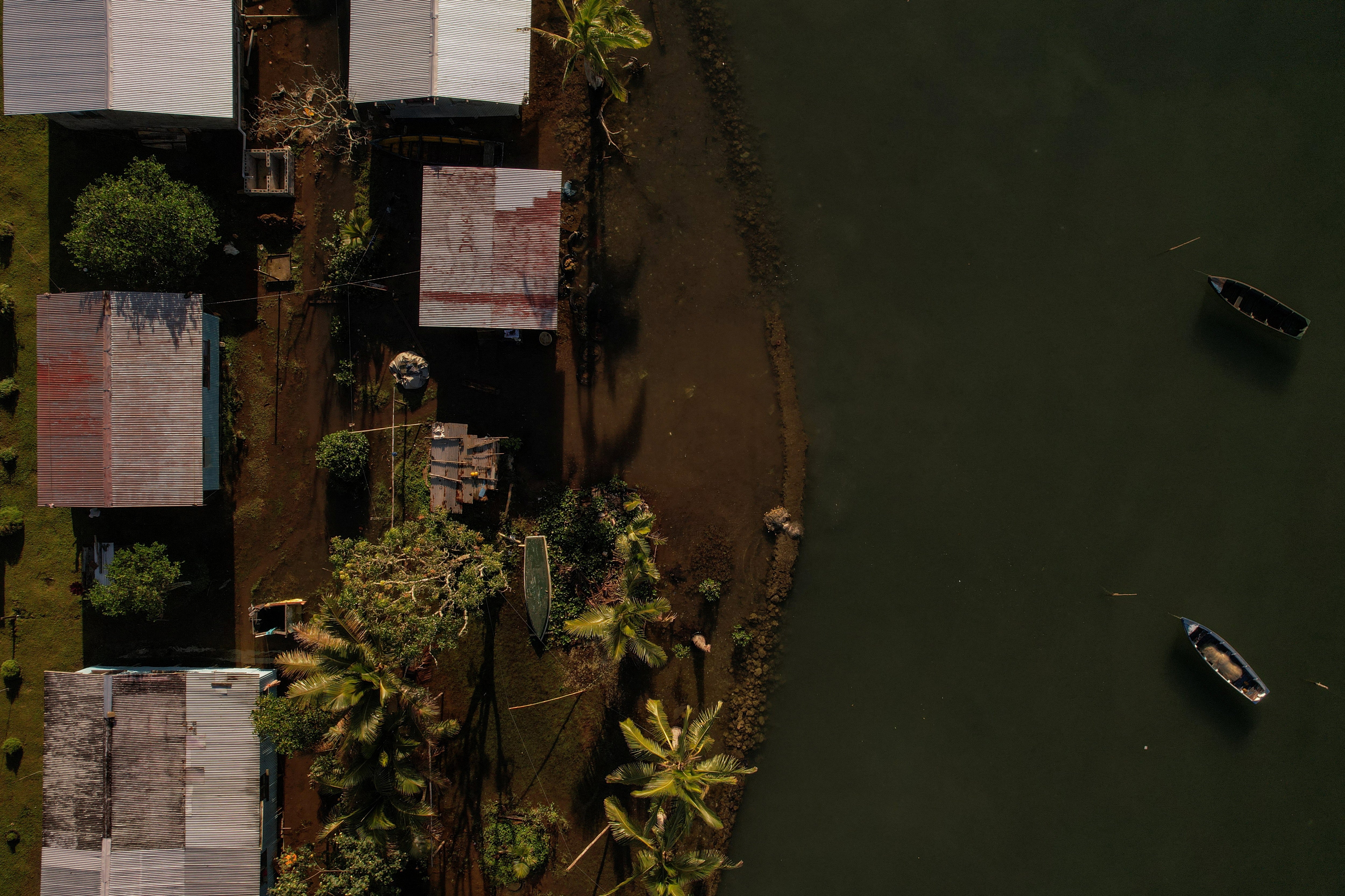 Seawater floods past an ineffective seawall into the community of Veivatuloa village