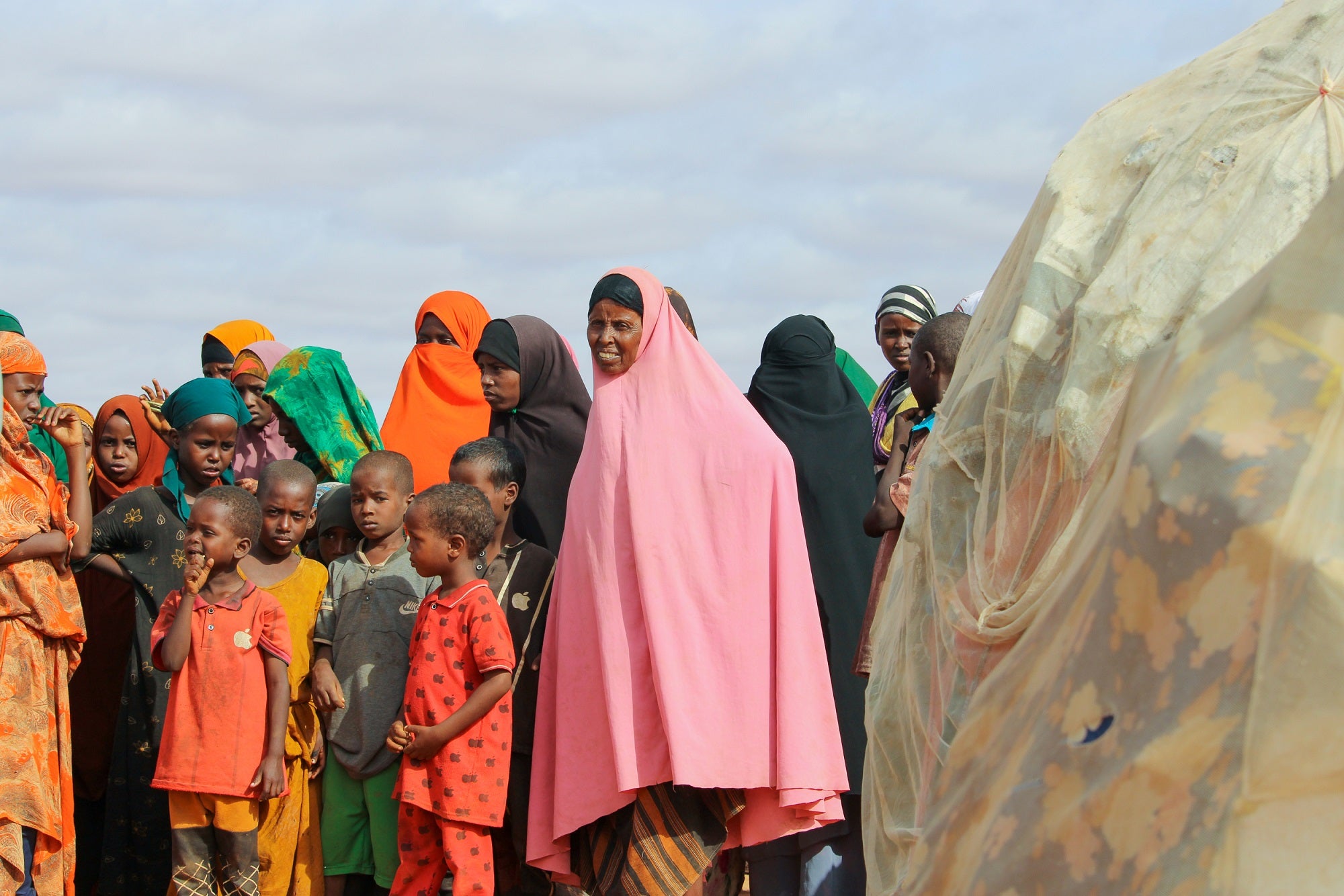 Internally displaced people near their makeshift tents at the Kabasa IDP camp