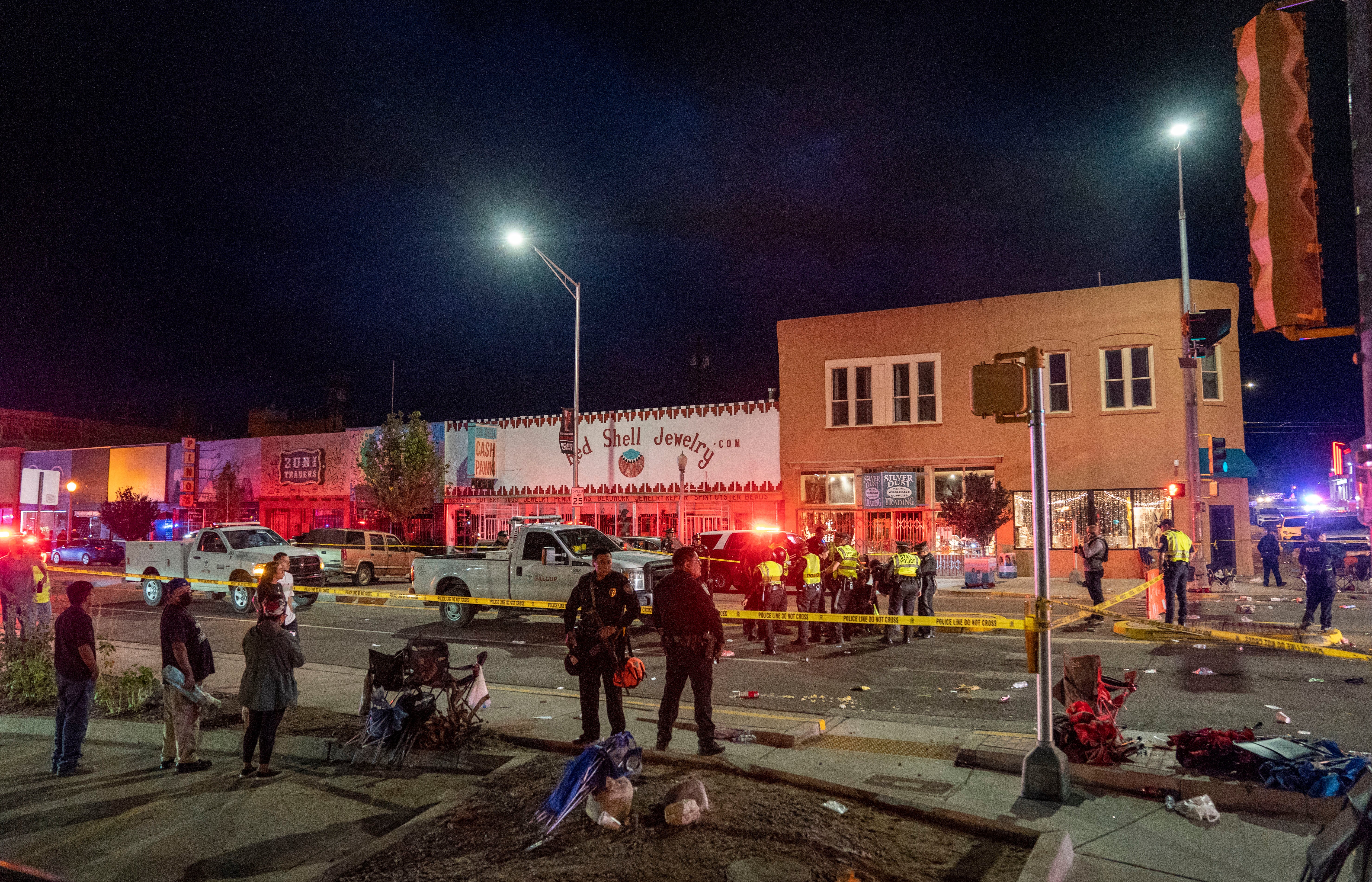 Police section off the site where an SUV came to an abrupt stop after a driver careened through the parade route of the Intertribal Ceremonial Centennial Celebration. in Gallup, New Mexico, Thursday, Aug. 4. 2022.