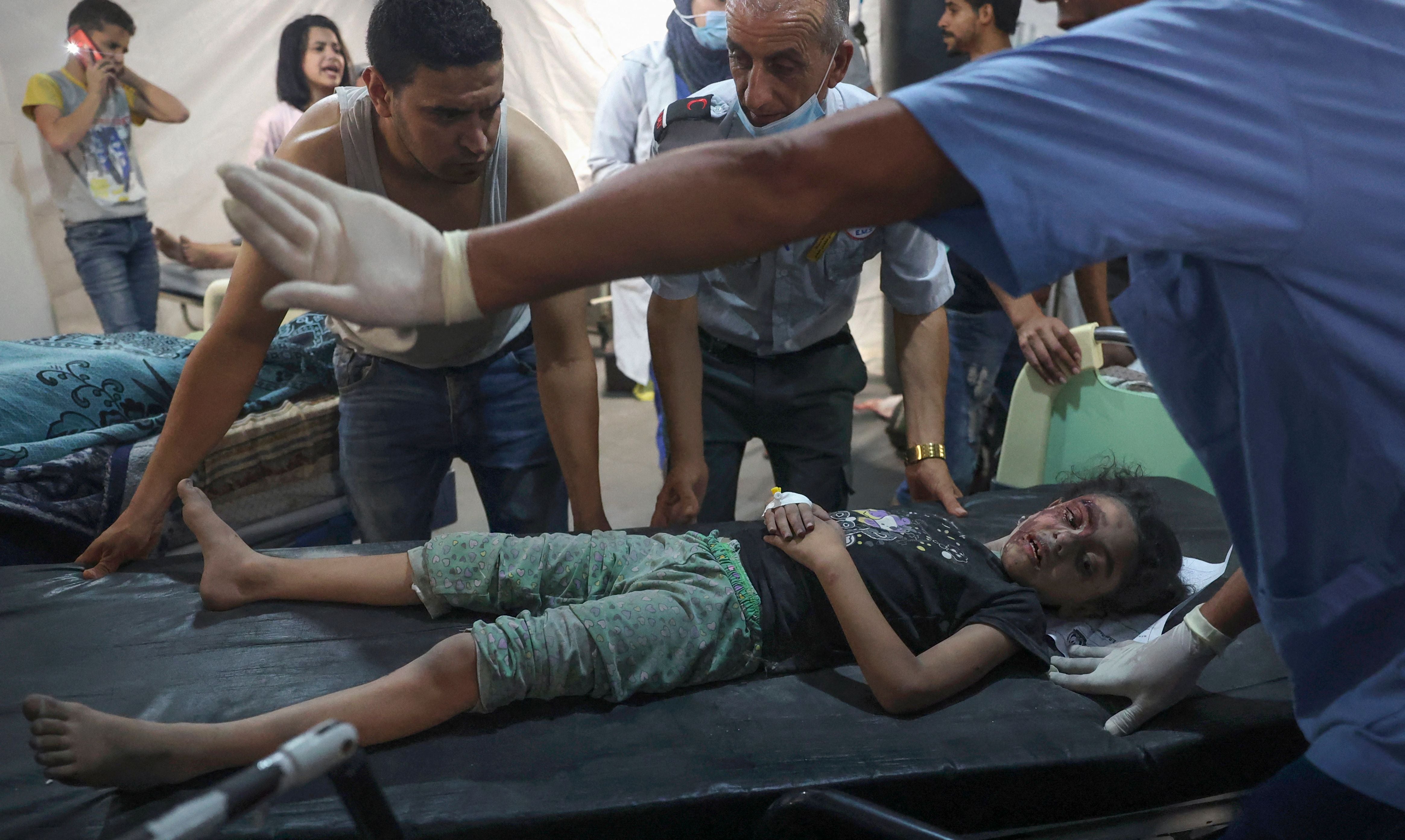 Palestinian medics transport an injured girl to the hospital following a reported Israeli strike in Rafah in the southern Gaza Strip,