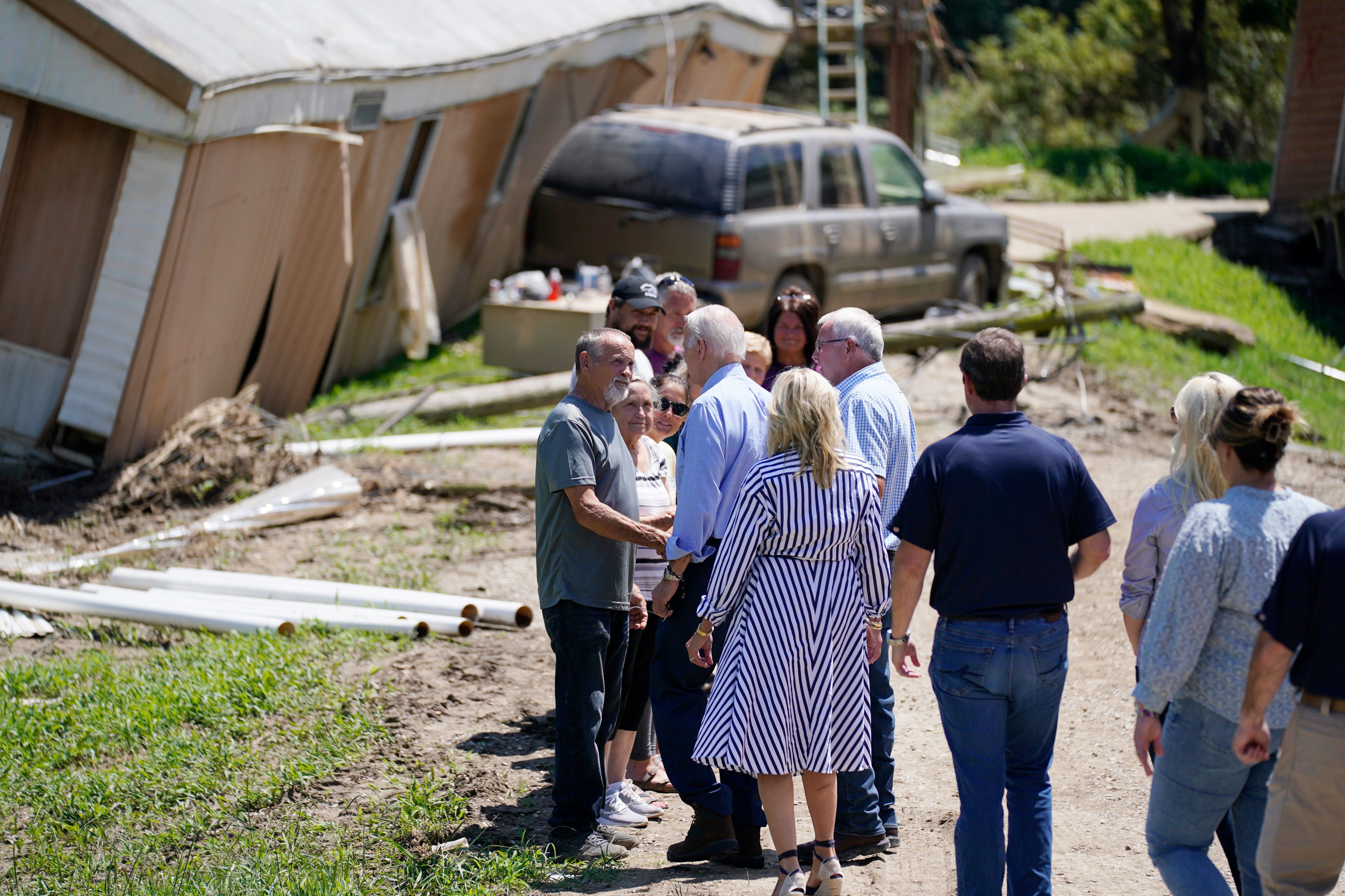 President Joe Biden and first lady Jill Biden and others, tour a neighborhood impacted by flooding, Monday, August 8, 2022, in Lost Creek, Kentucky