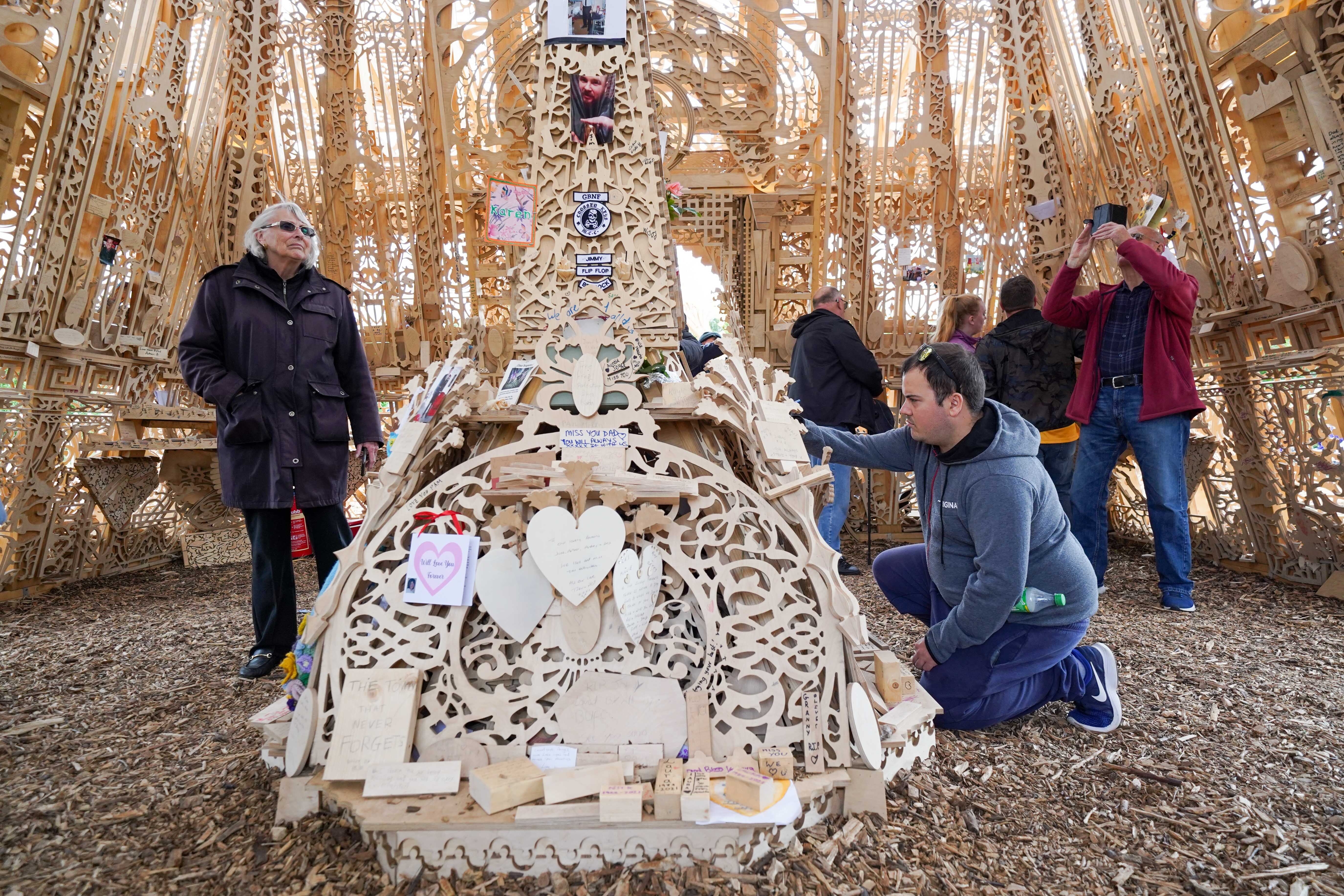 People view and leave messages at Sanctuary, a national memorial to honour the UK’s loss to Covid-19 in Bedworth, Warwickshire (Jacob King/PA)