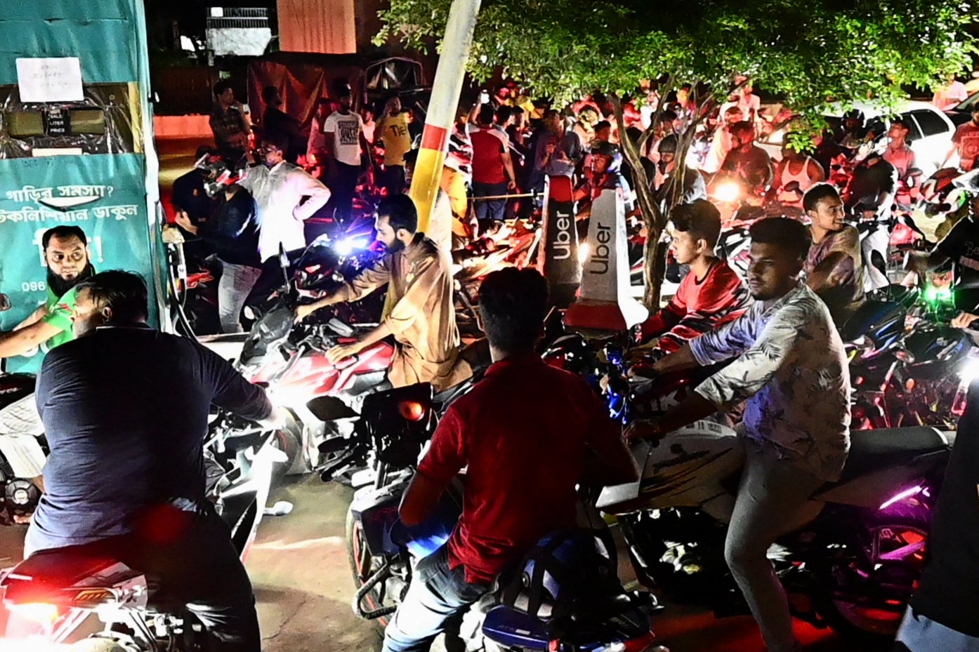 Bangladeshis line up at a gas station in Dhaka after government has increased fuel oil price in Bangladesh