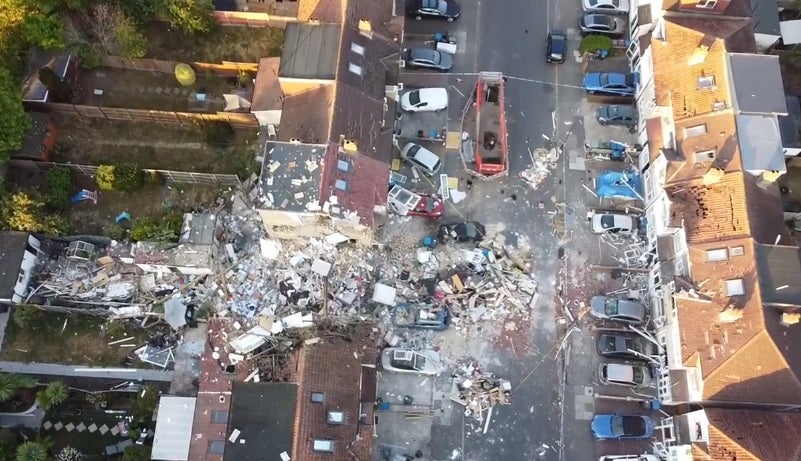 Bricks, mortar and other debris can be seen strewn across the road at the front of the property