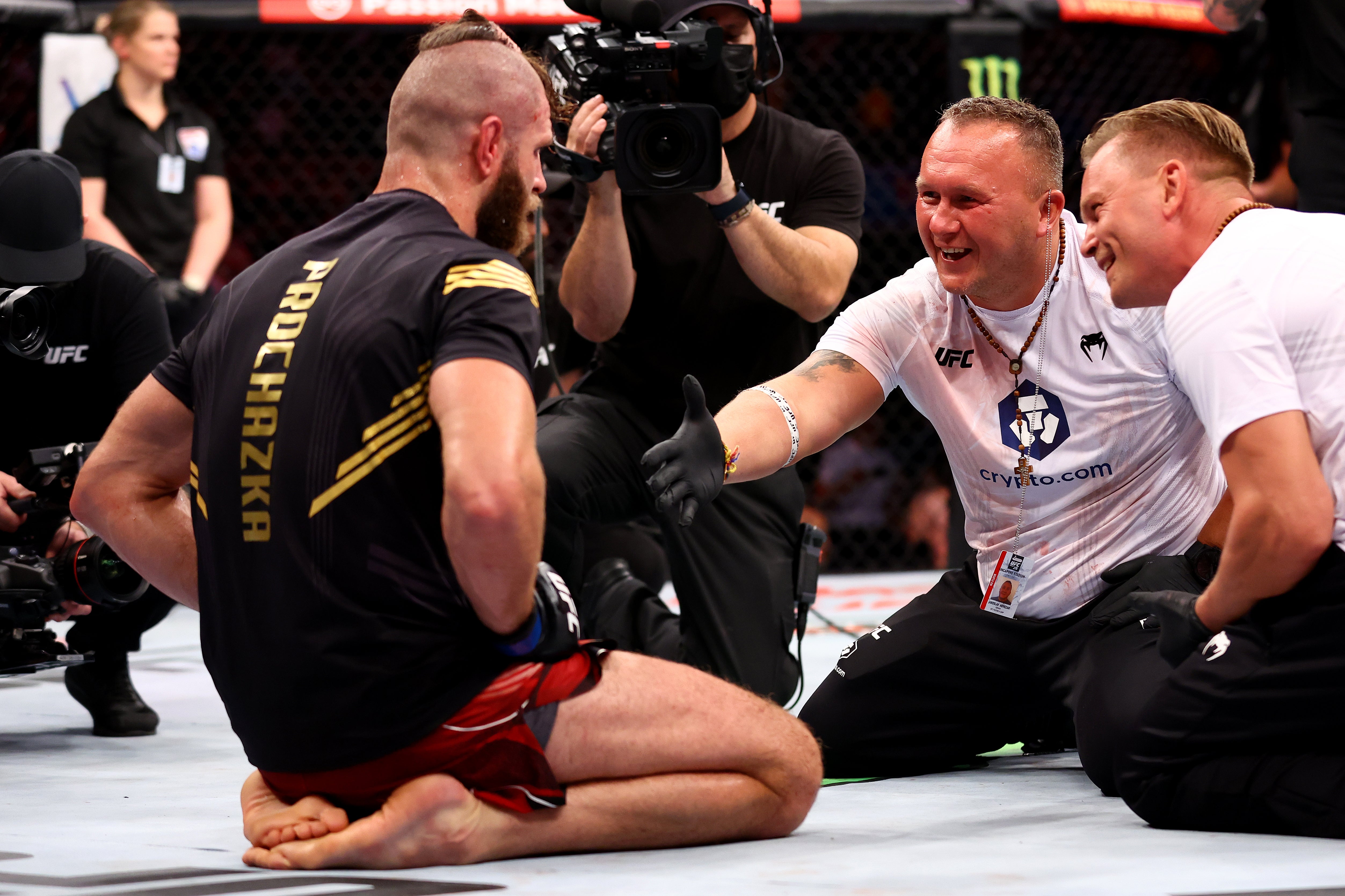 An exhausted but relieved Jiri Prochazka is congratulated by his team after beating Glover Teixeira