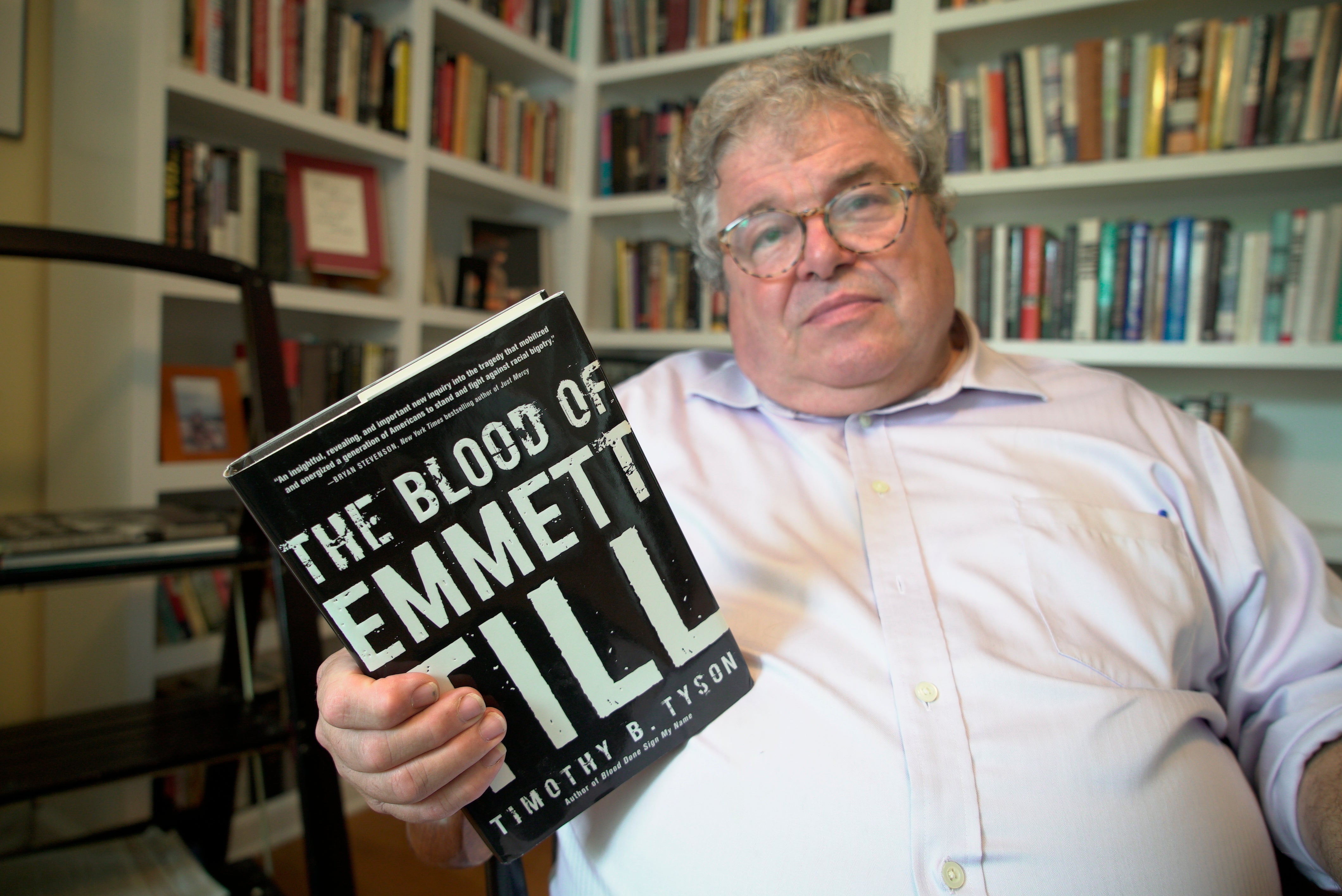 Author Timothy Tyson holds a copy of his book on the lynching of Emmett Till, in which