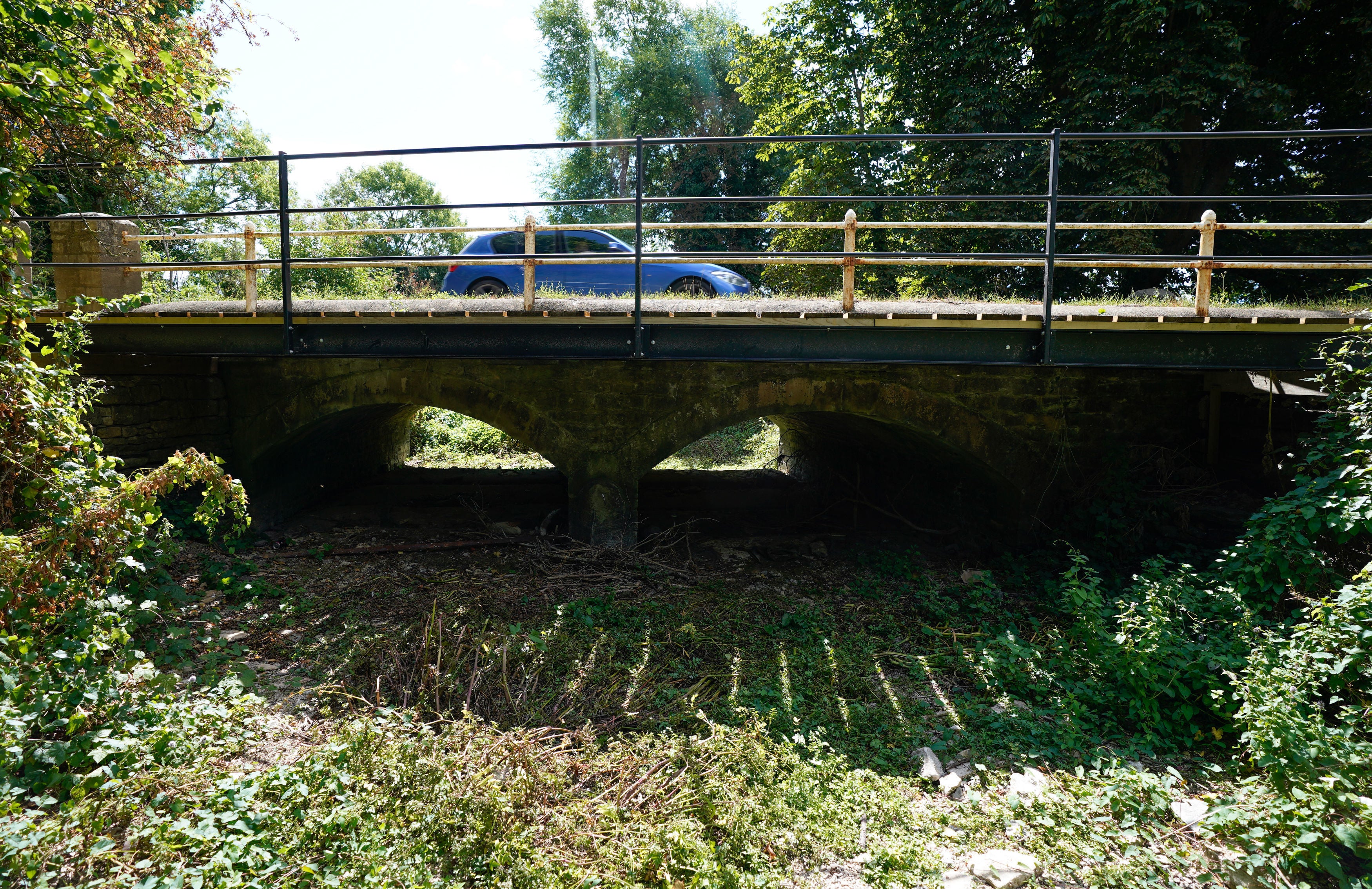 A car passes over a bridge over a dried up river bed near the mouth of the Thames in Gloucestershire