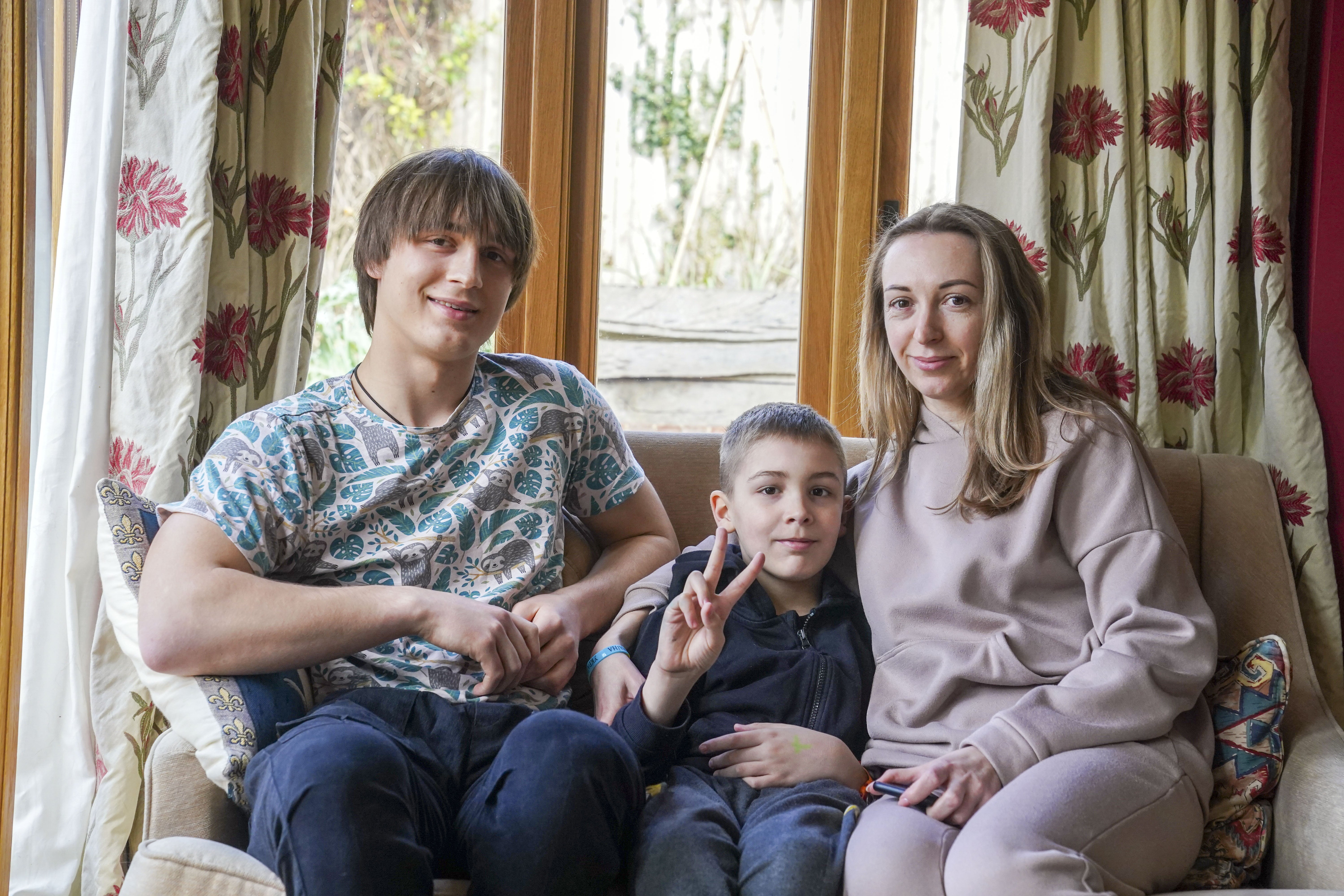 Ukrainian refugees Yaroslav Kryvoshyia (left) and Irinia Kryvoviaz (right) with her son Sasha, as they settle into their new home in North Moreton, Oxfordshire under the government scheme