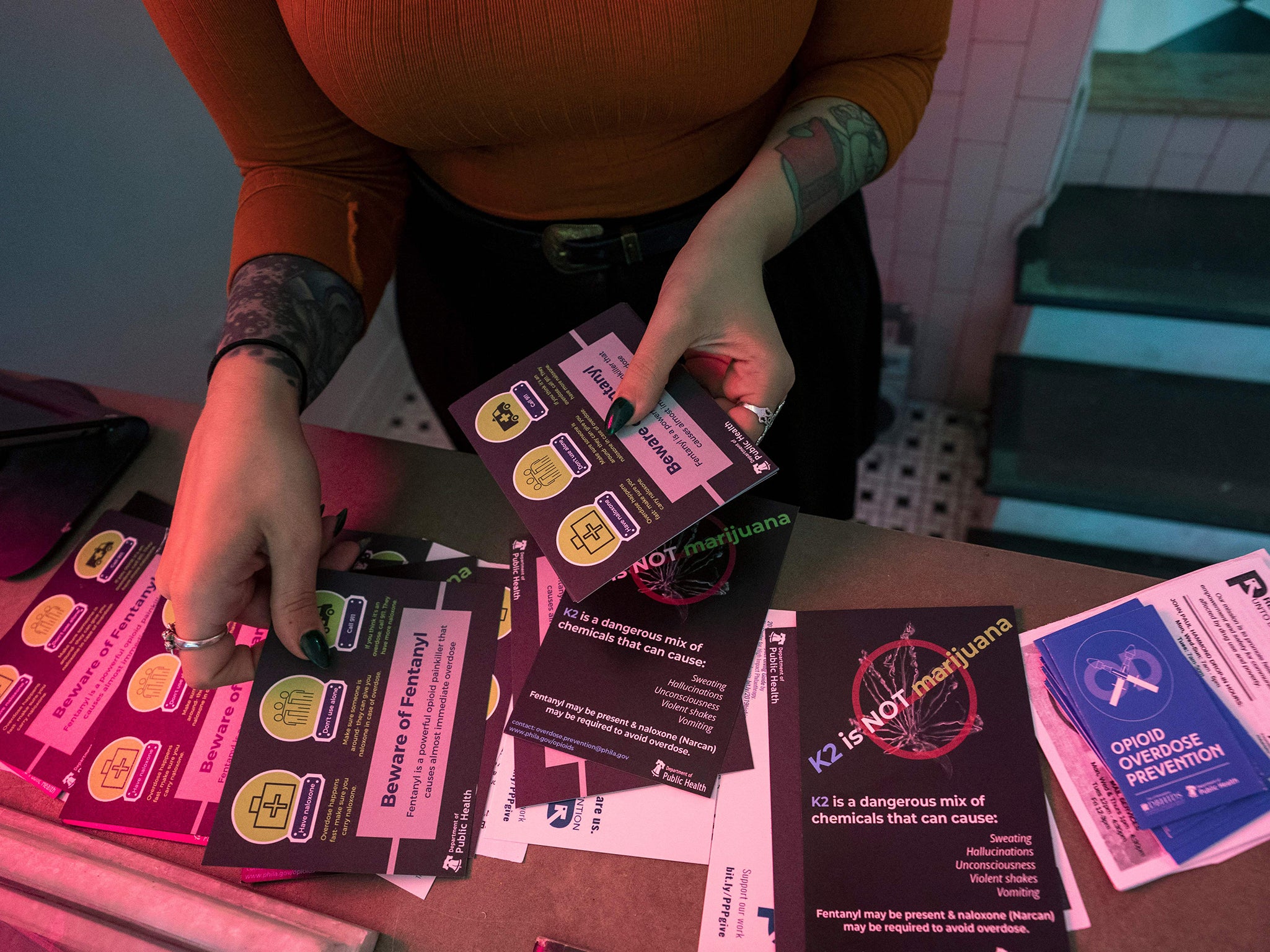 A volunteer in Philadelphia, Pennsylvania, sorts through information packets on how to help someone who has overdosed on opioids