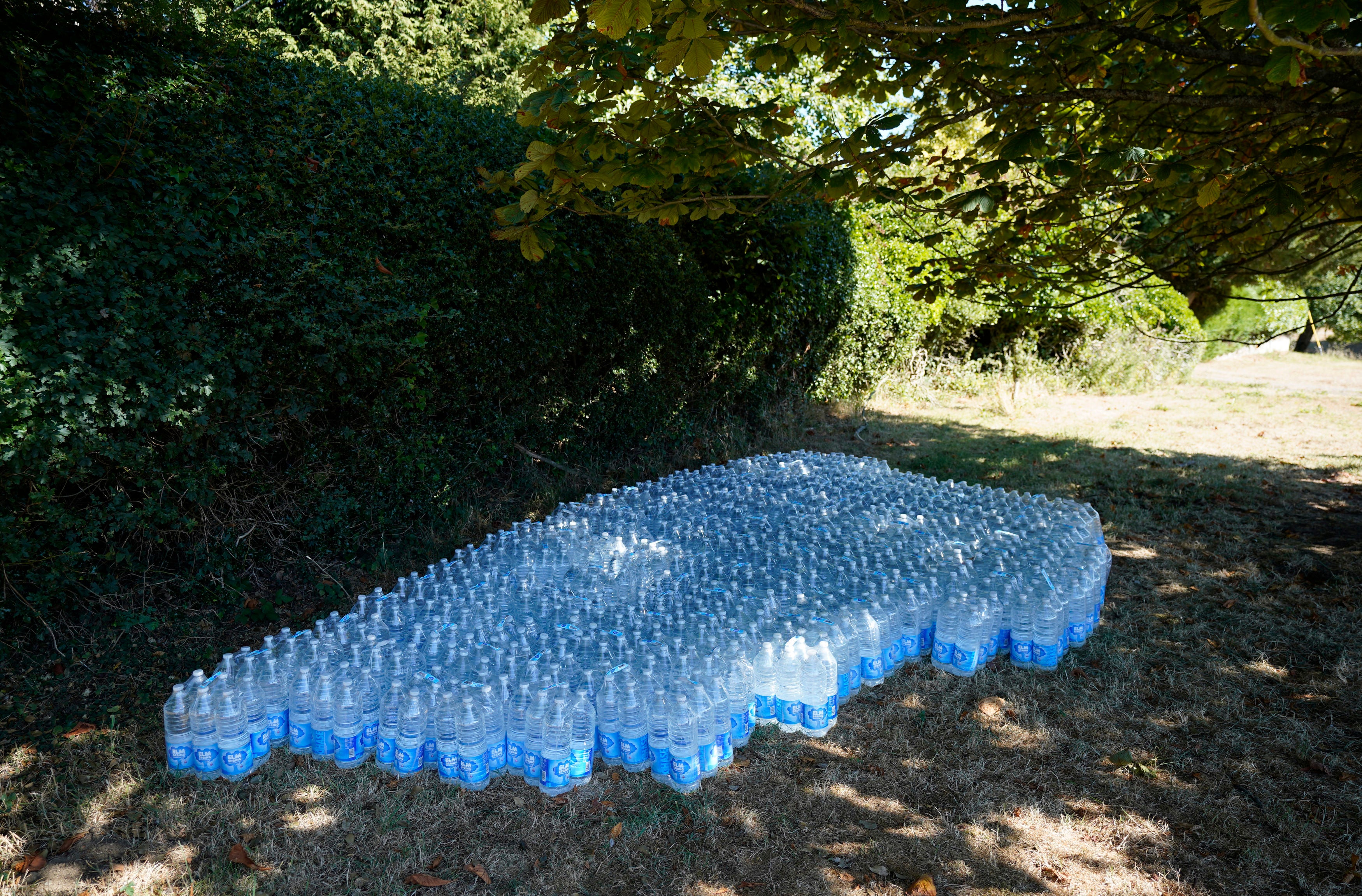 Bottled water left under shade for residents in Oxfordshire village