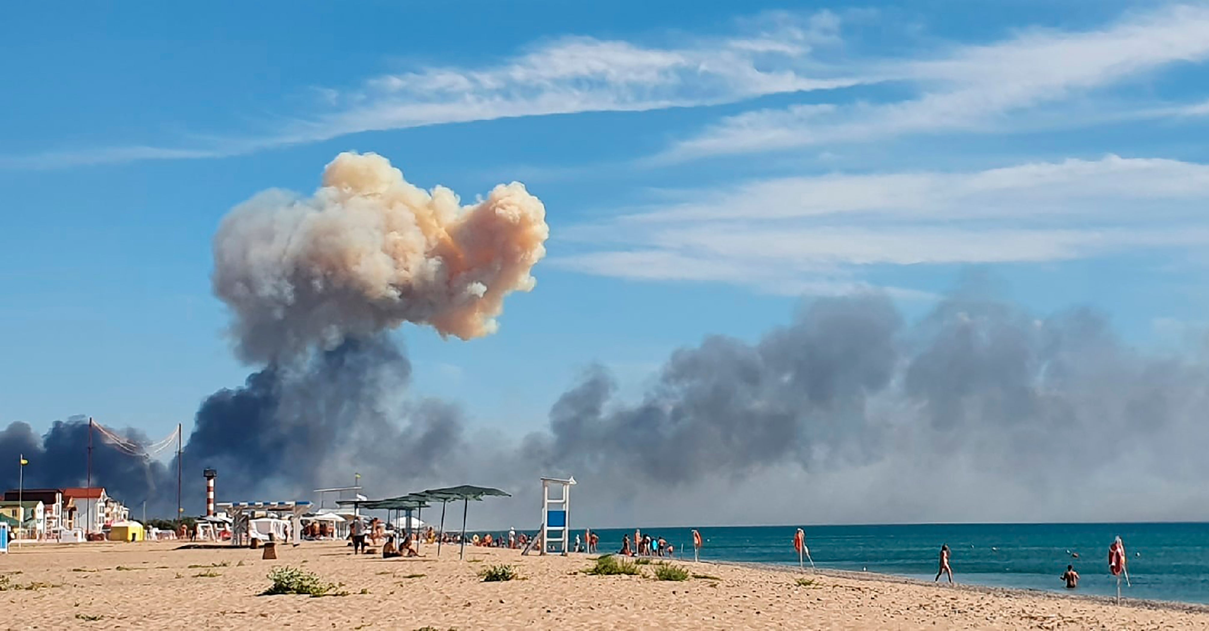 Rising smoke can be seen from the beach at Saky after explosions were heard from the direction of a Russian military airbase near Novofedorivka, Crimea