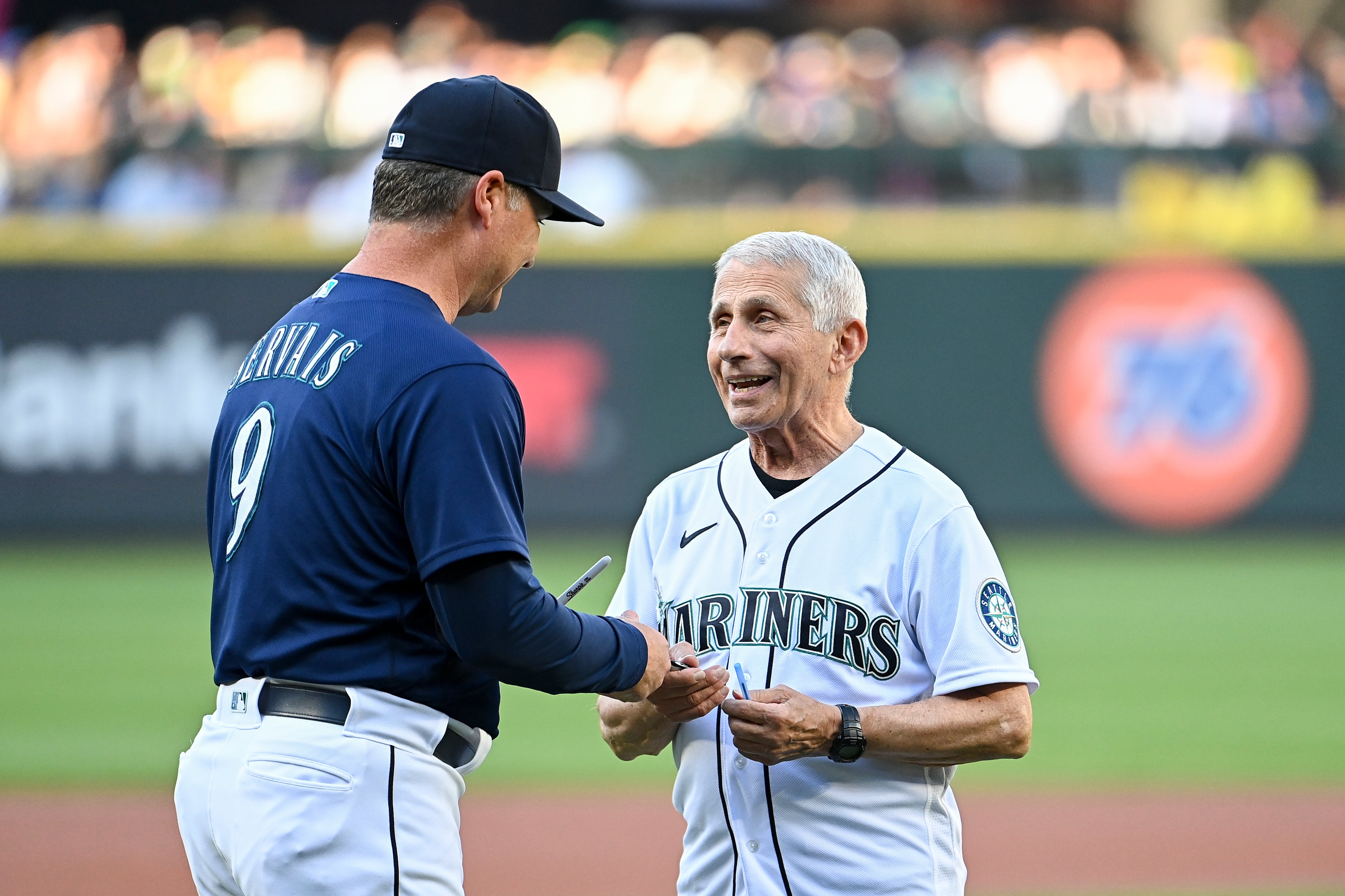 Manager Scott Servais #9 (L) of the Seattle Mariners and Dr. Anthony Fauci, director of the National Institute of Allergy and Infectious Diseases and chief medical advisor to the U.S. president, meet before the game between Mariners and the New York Yankees