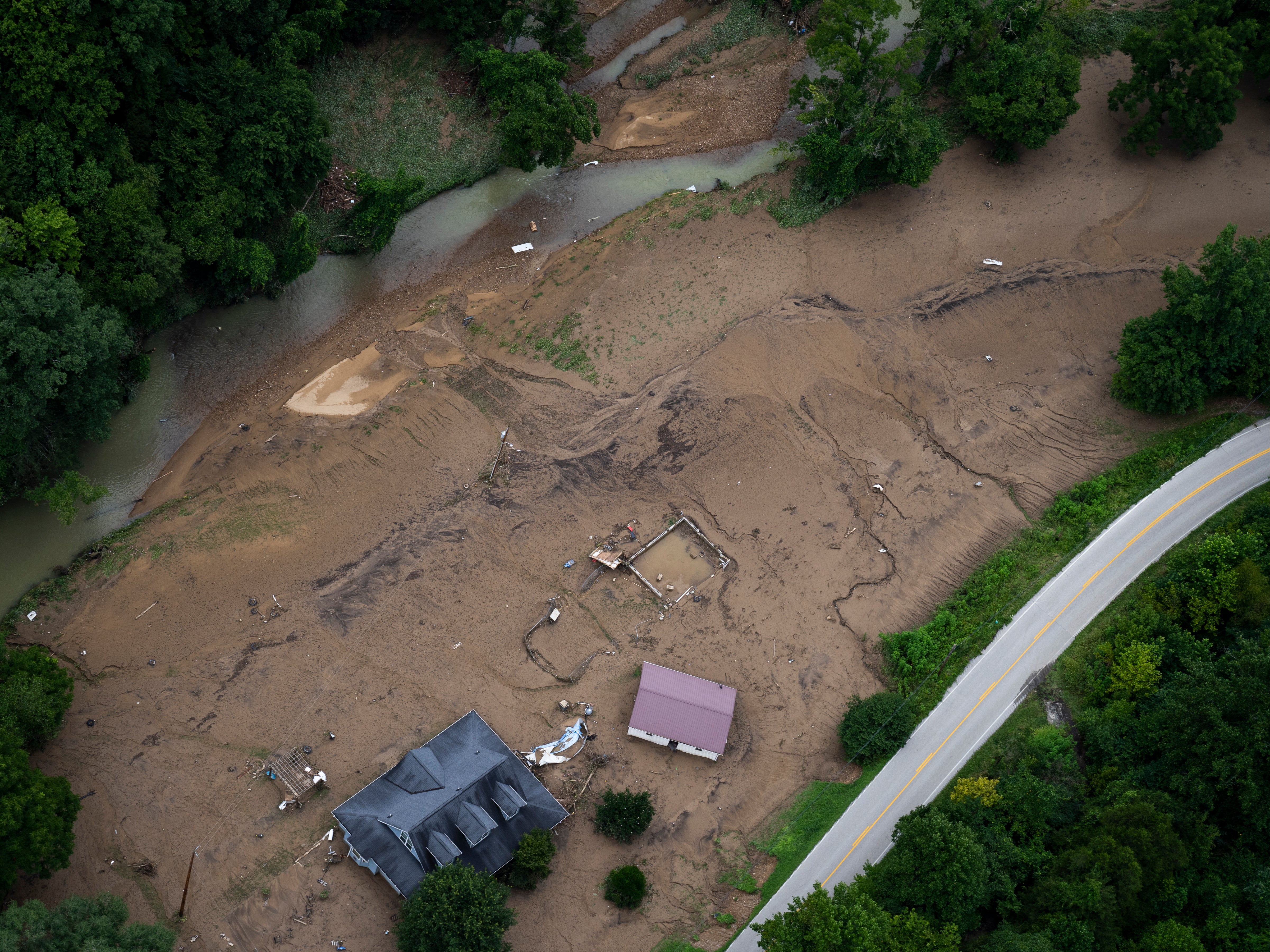 In this aerial view, flood damage is visible as the Kentucky National Guard fly a recon and rescue mission on July 30, 2022 in Breathitt County near Jackson, Kentucky