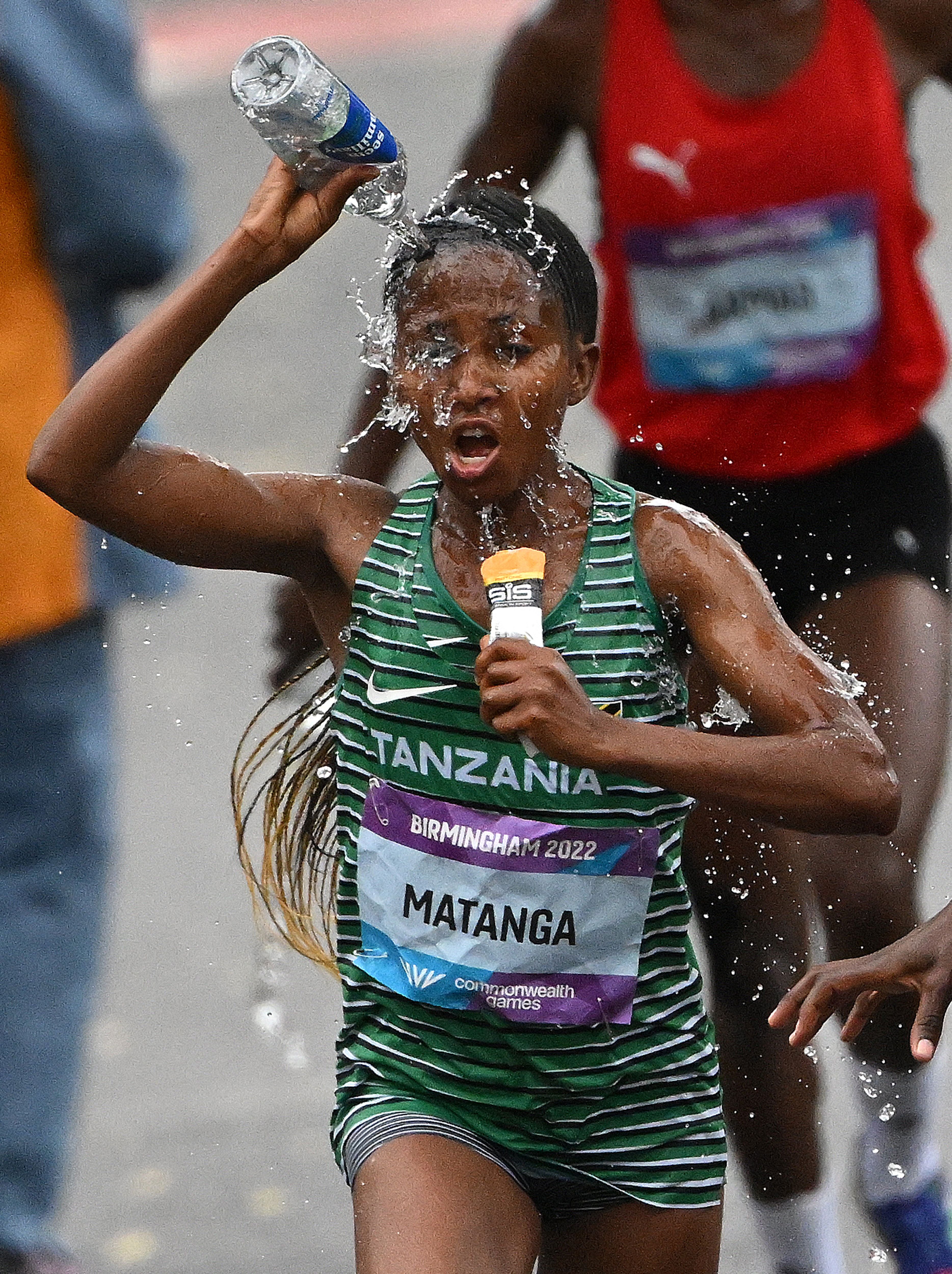 Tanzania’s Failuna Matanga douses herself in water during the Commonwealth Games Marathon