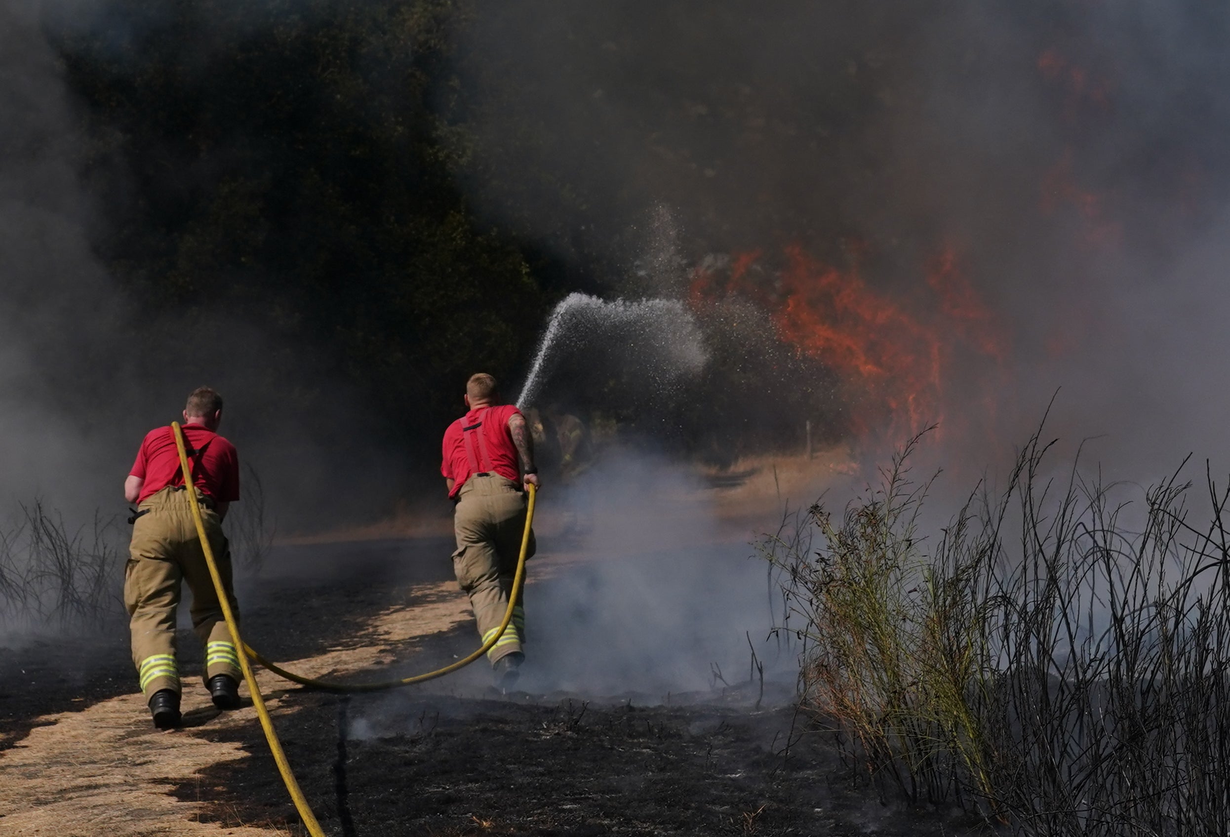 More extreme heat and drought conditions are expected in the southern half of the UK this weekend, while the northern half is set to be struck by thunderstorms and floods (Yui Mok/PA)