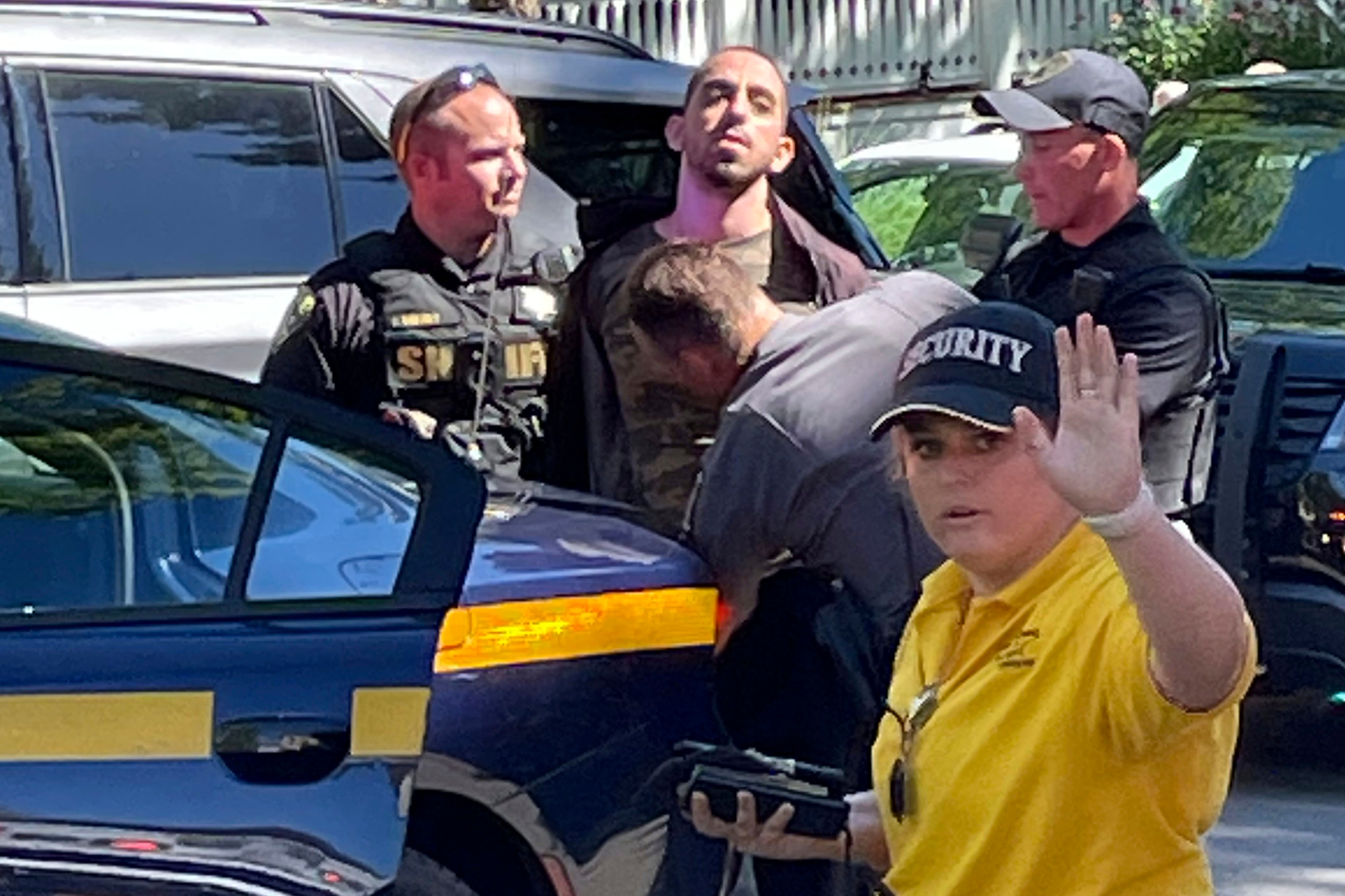 Law enforcement officers detain Hadi Matar outside the Chautauqua Institution