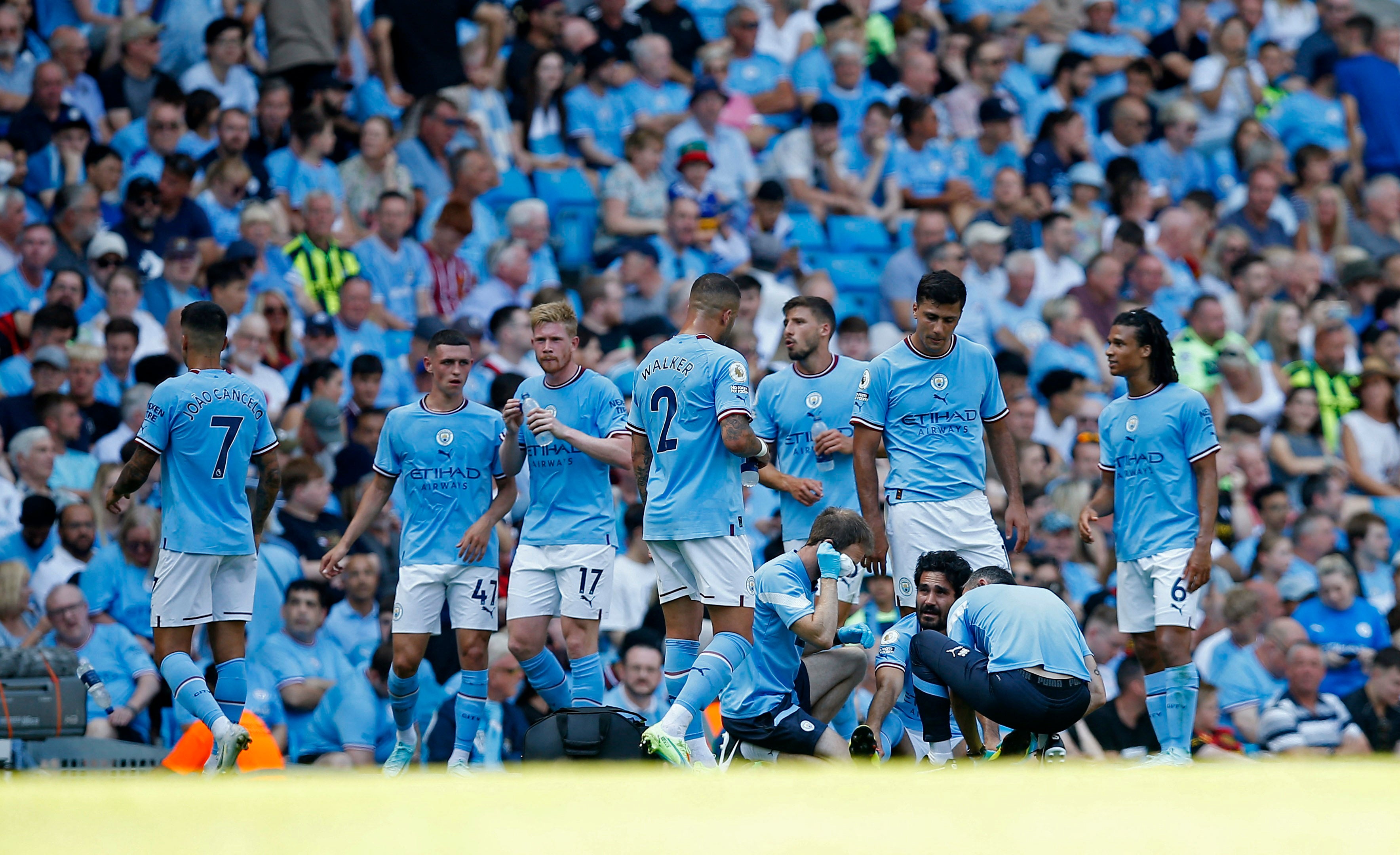 Manchester City’s Ilkay Gundogan, who opened the scoring, receives medical attention