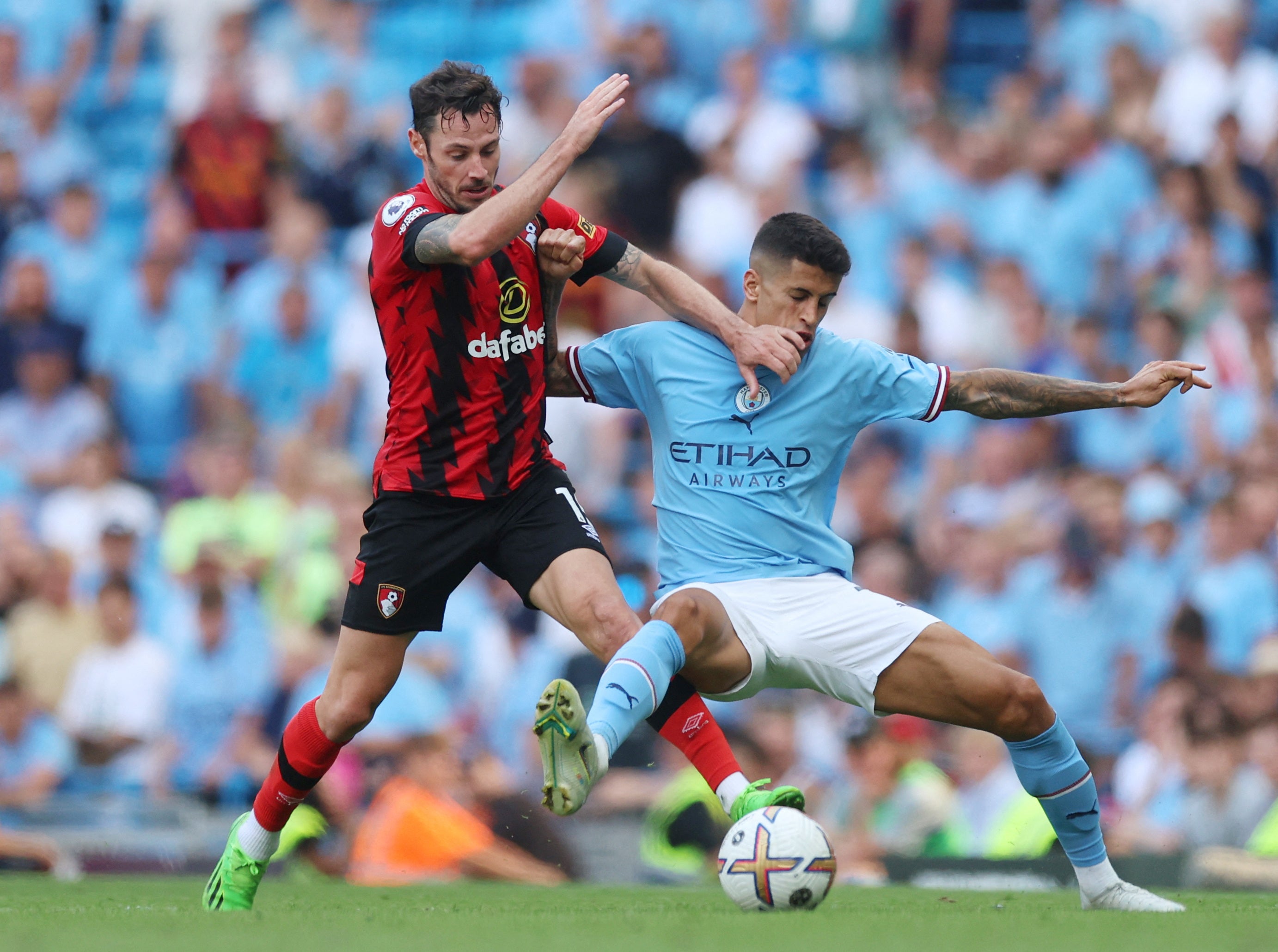 Bournemouth's Adam Smith tussles with Joao Cancelo