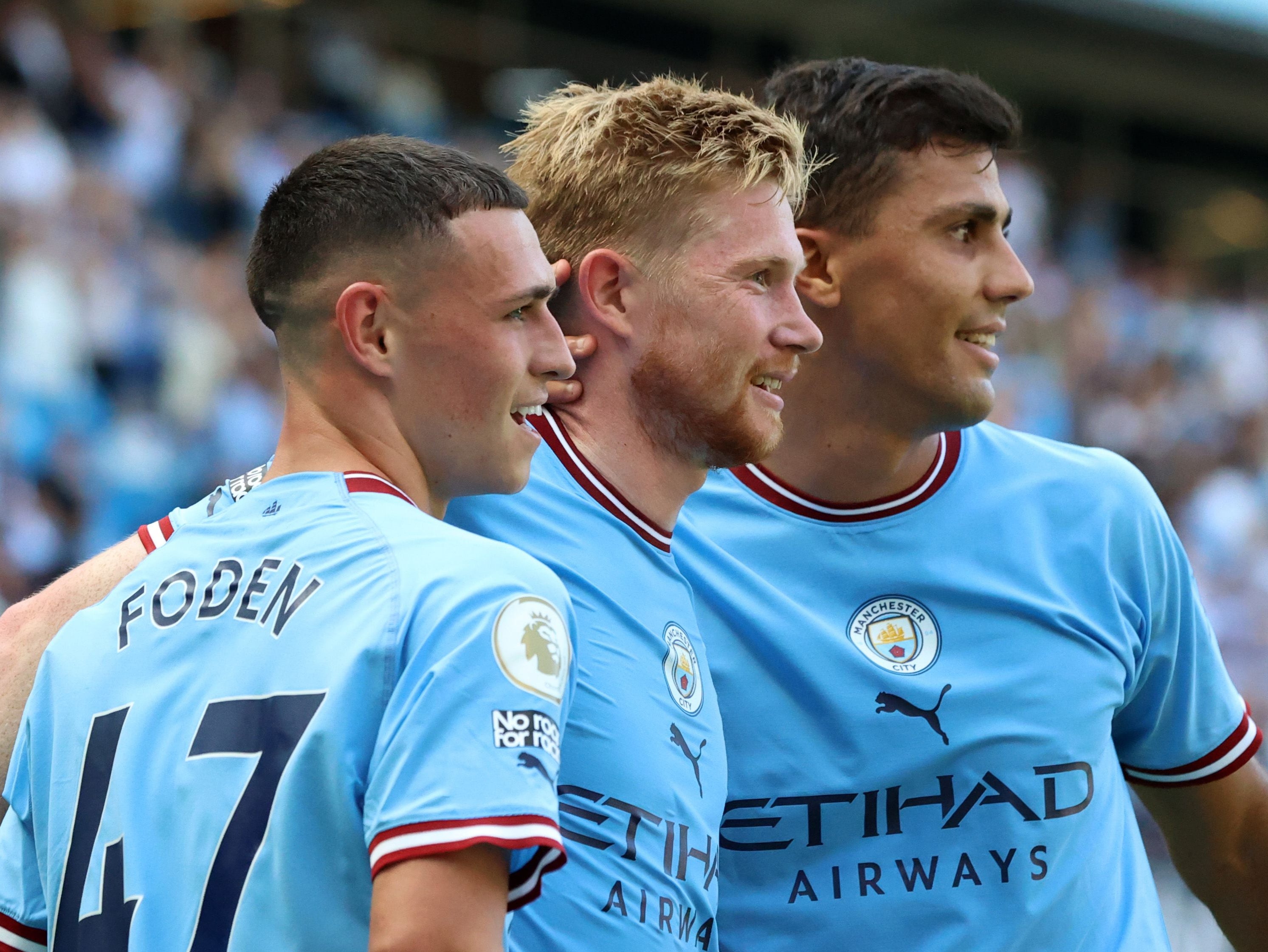 Kevin de Bruyne of Manchester City celebrates with teammates Phil Foden and Rodri after scoring his side’s second goal after 30 minutes