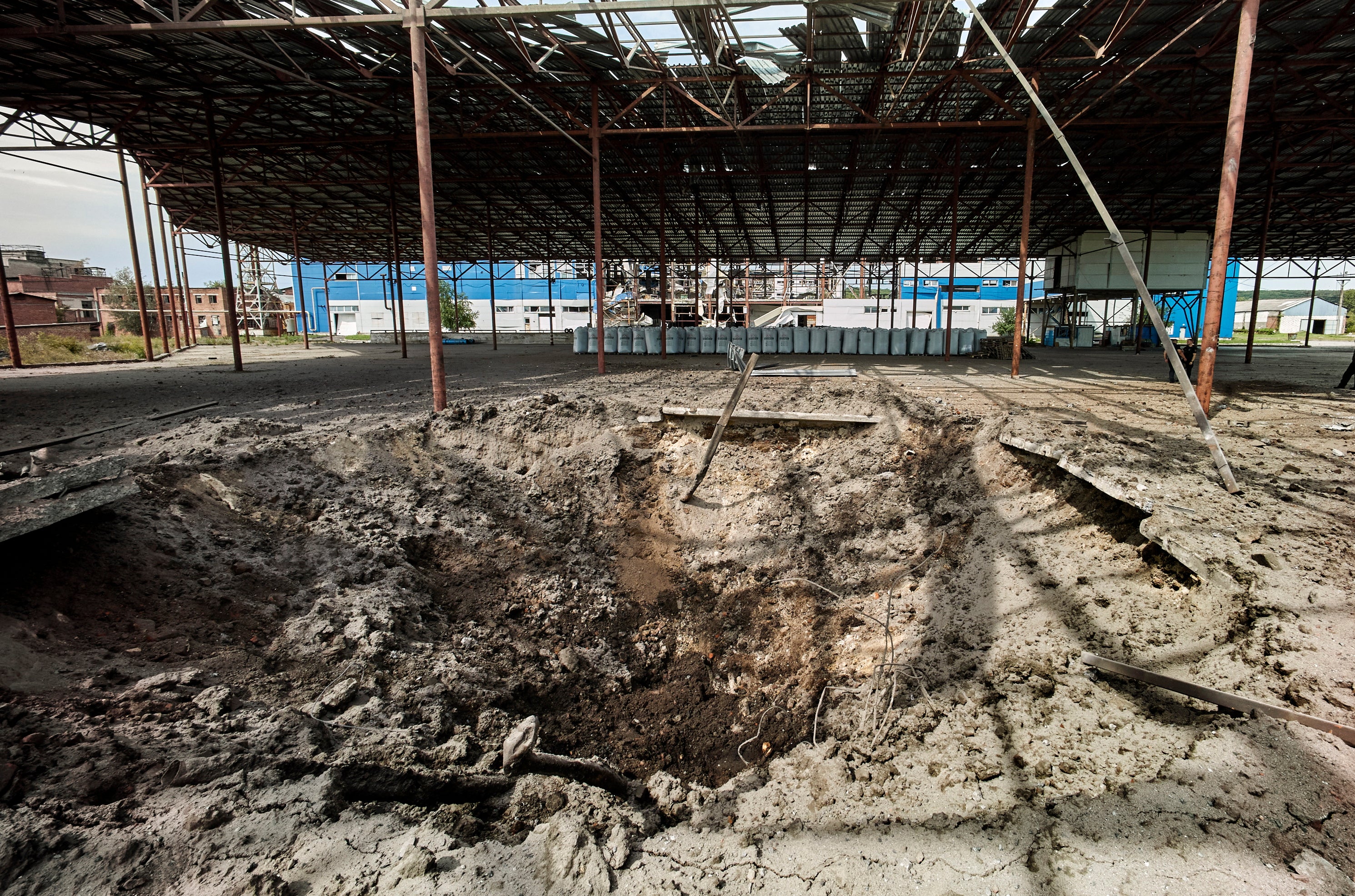 A shelling hole at a factory building damaged in a rocket hit in the small city of Merefa of Kharkiv area