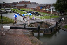 Videos show scale of flash flooding as rain finally hits parched UK, with warnings of more to come