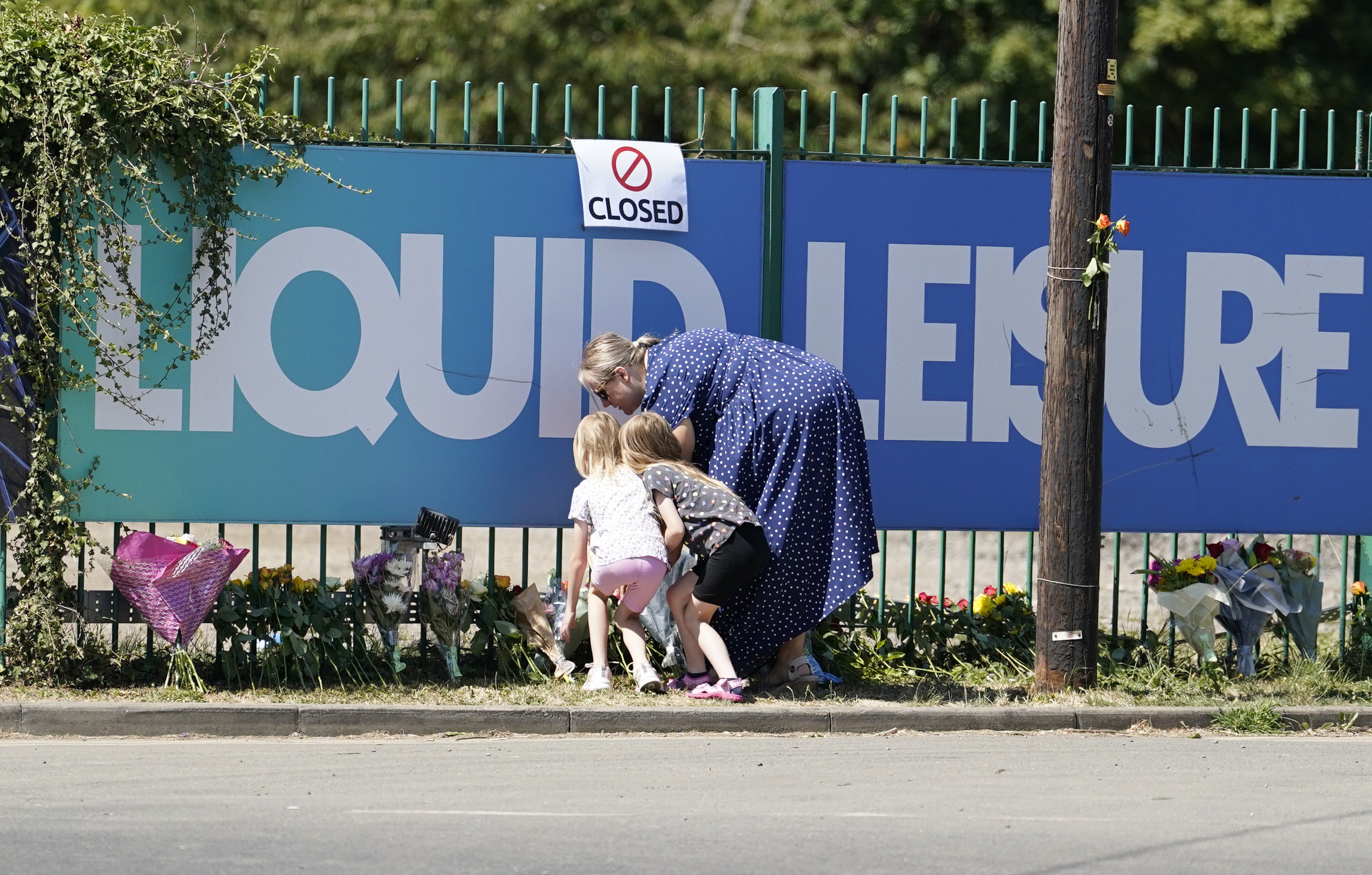 People leave flowers outside Liquid Leisure (Andrew Matthews/PA)