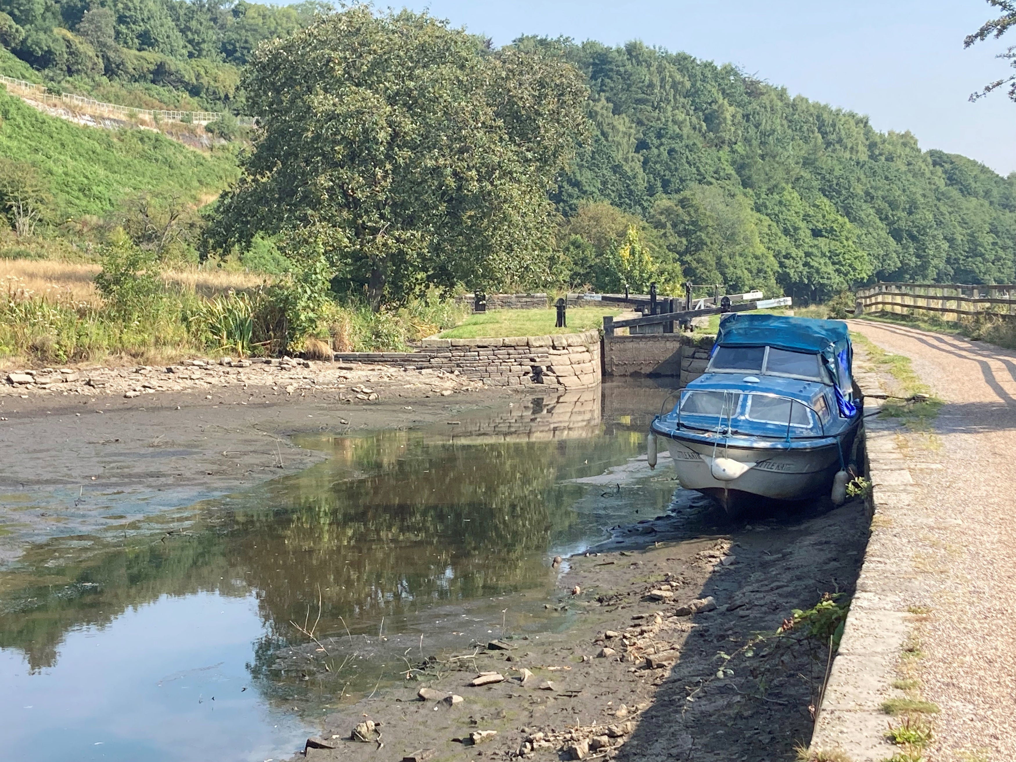 A boat lies in the dried up Huddersfield narrow canal near Linthwaite in the Colne Valley after a drought was declared in the area