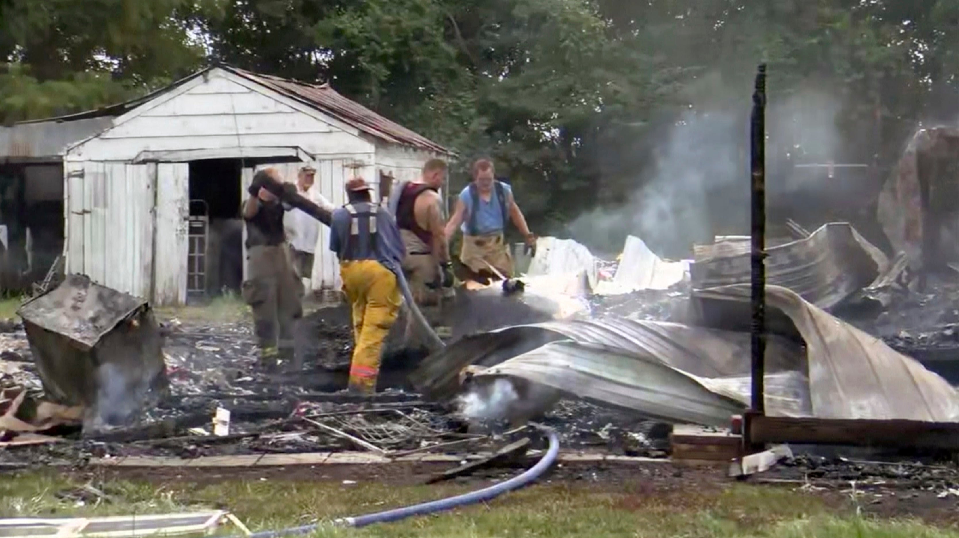 This photo from video by KFVS-TV shows people working the scene of a house explosion in Wyatt, Missouri, on 15 August