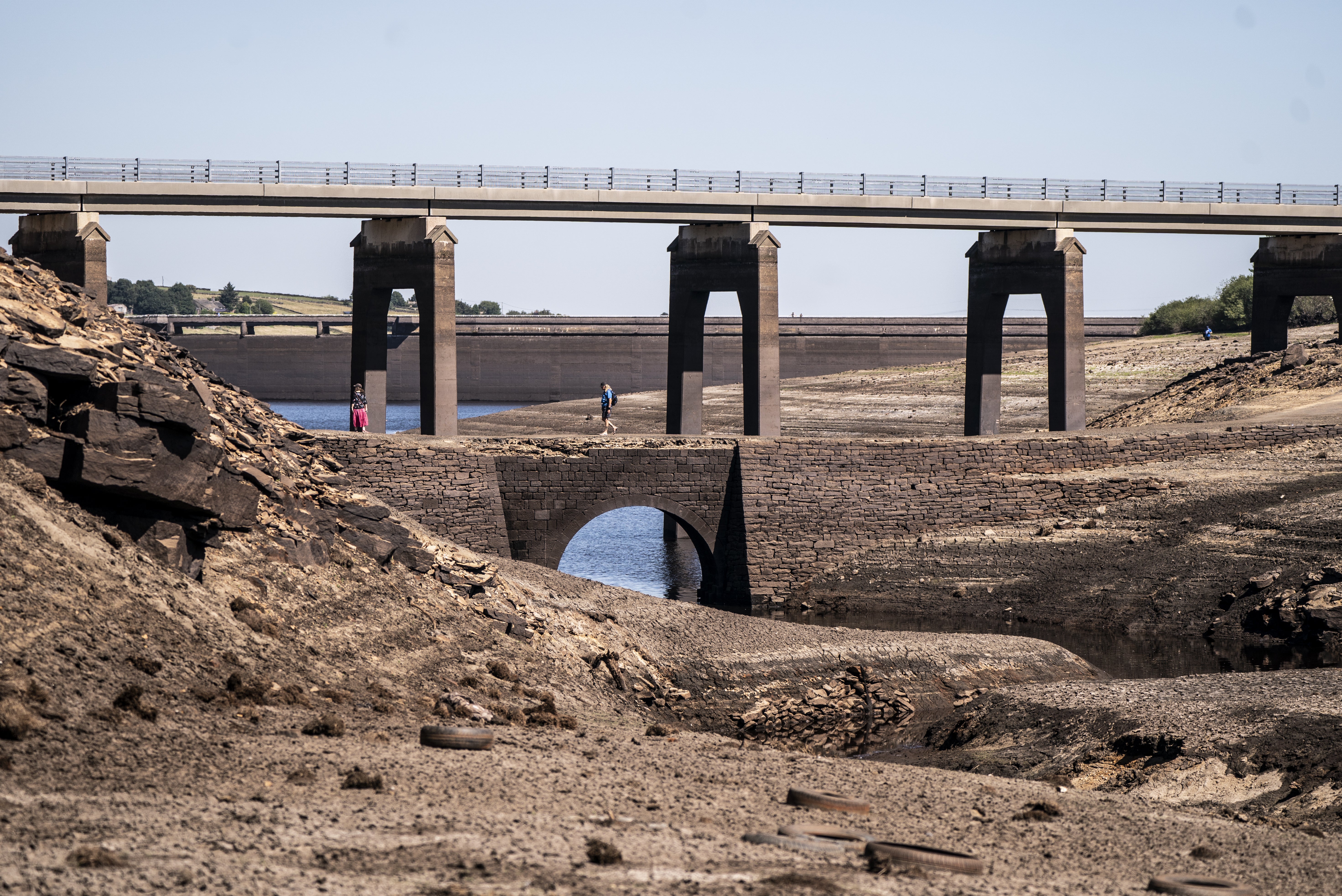 The earth has become dry and cracked at the Baitings Reservoir in Ripponden, West Yorkshire, during the bout of prolonged dry weather (Danny Lawson/PA)