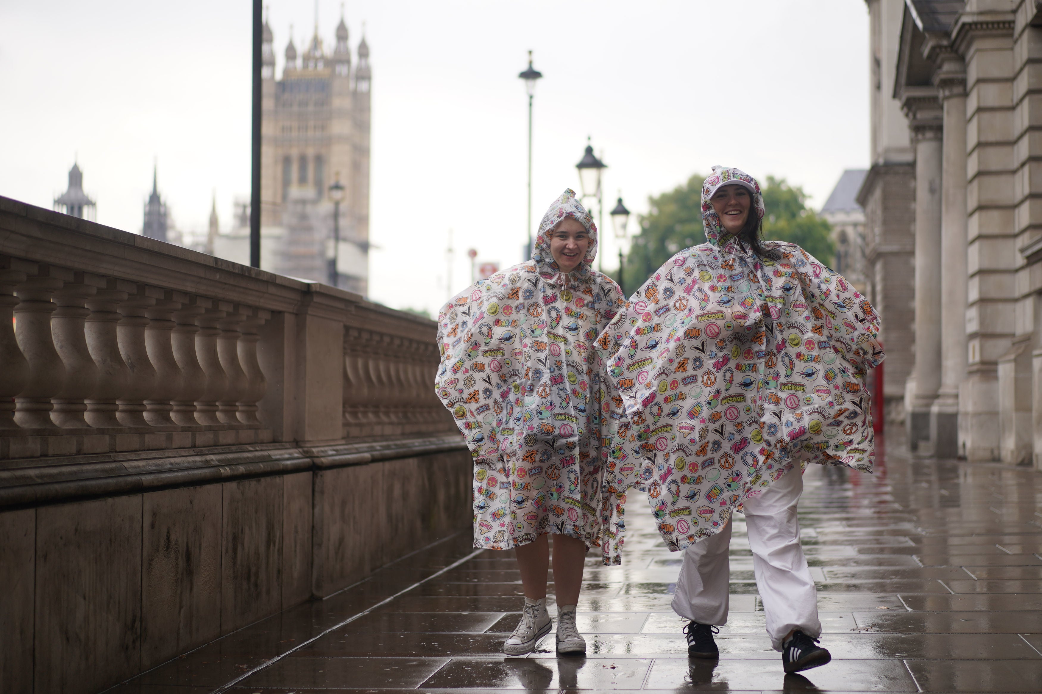 Tourists wear rain ponchoes on Whitehall