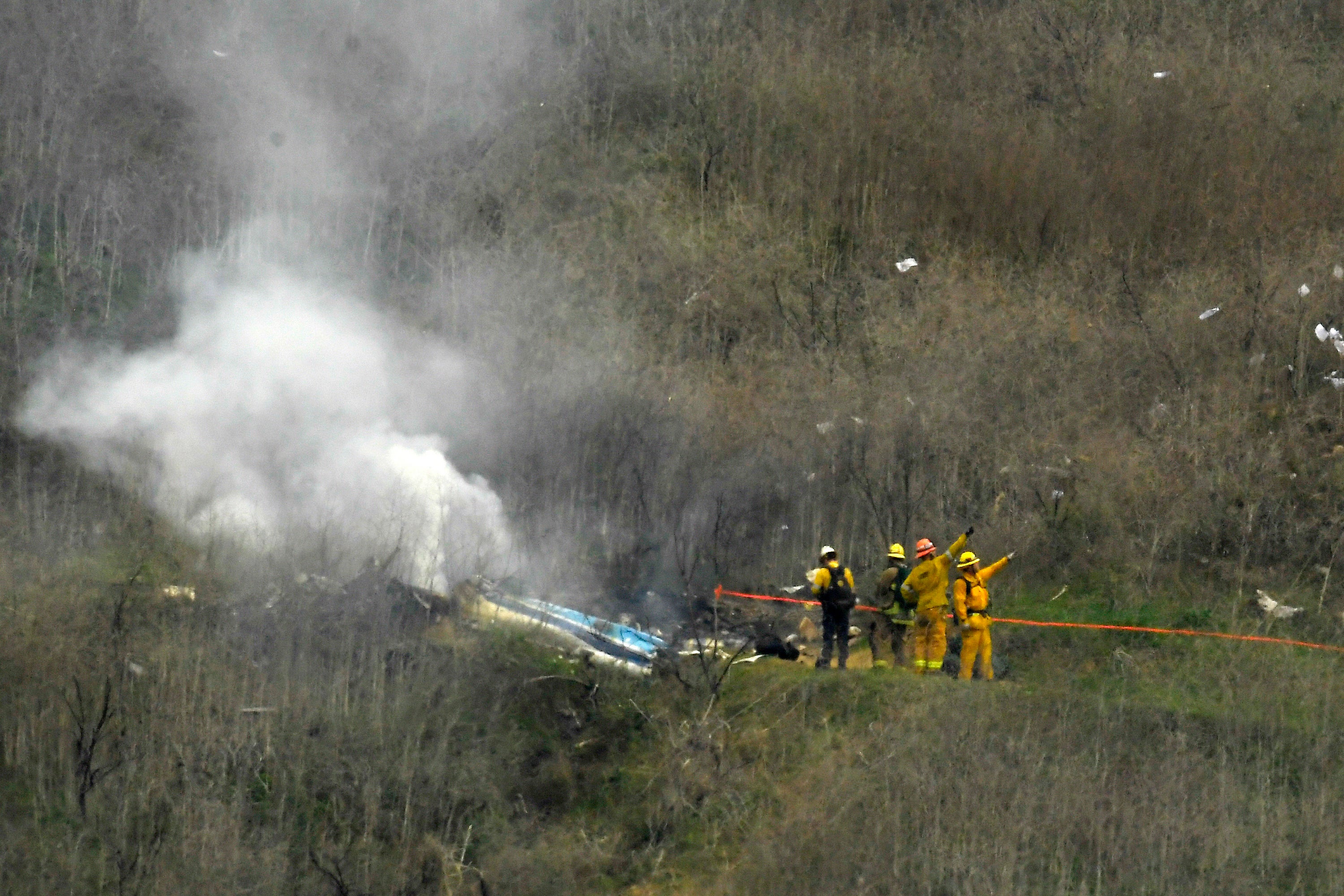 Firefighters work the scene of a helicopter crash