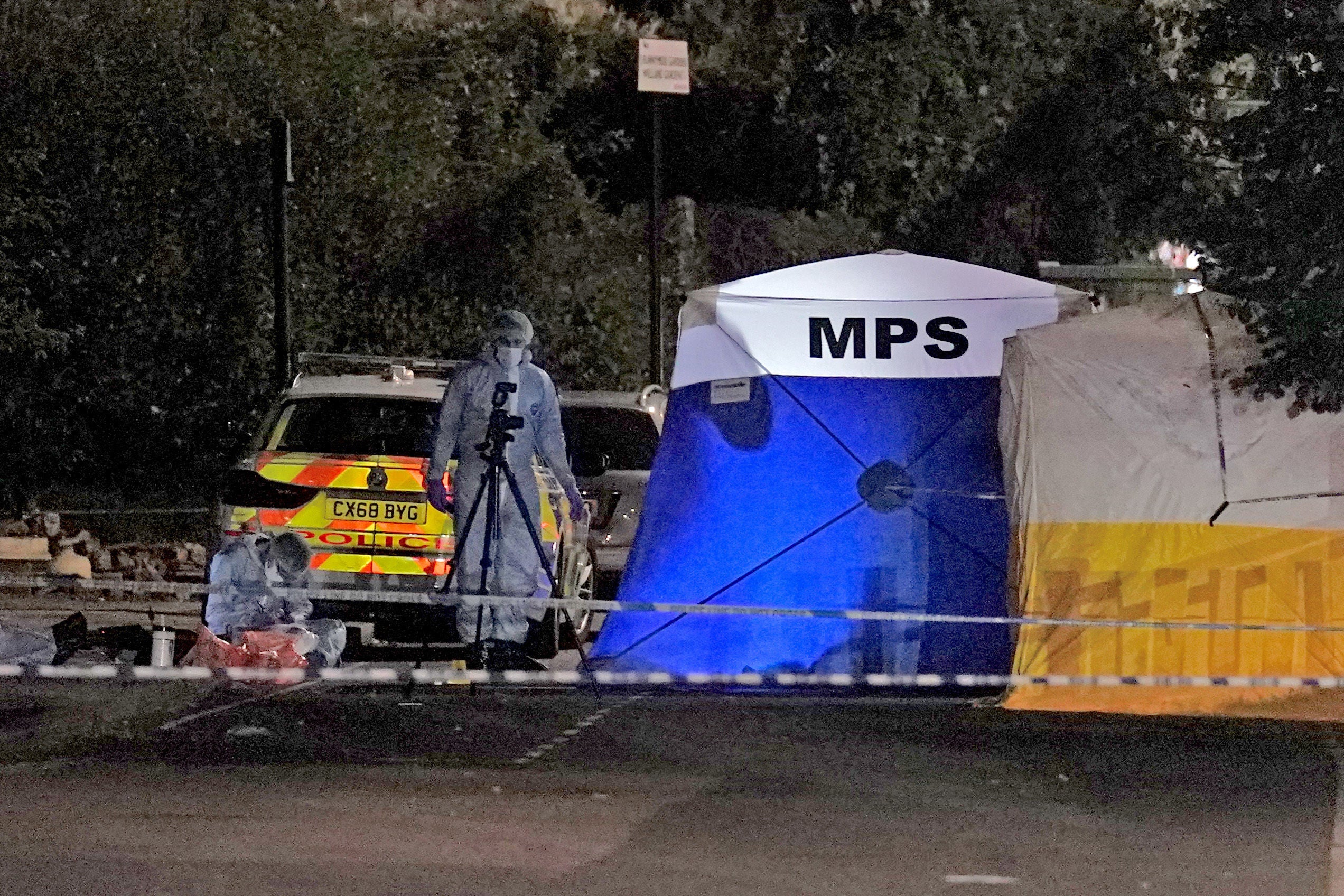 Police forensics officers at the scene of the fatal stabbing