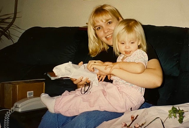 Darlene Jensen, now 49, poses with her young daughter, Caitlin, who is currently to regain full function after a freak injury during a neck adjustment